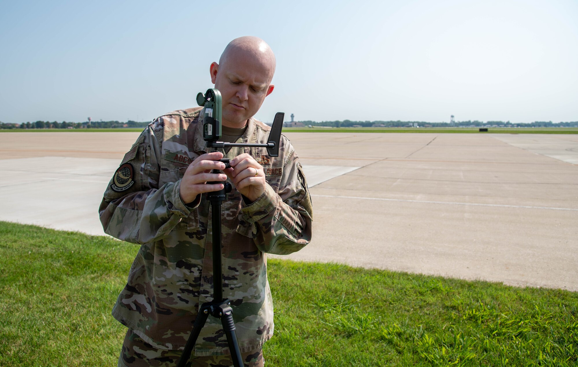 Man sets up hand held weather forecasting device