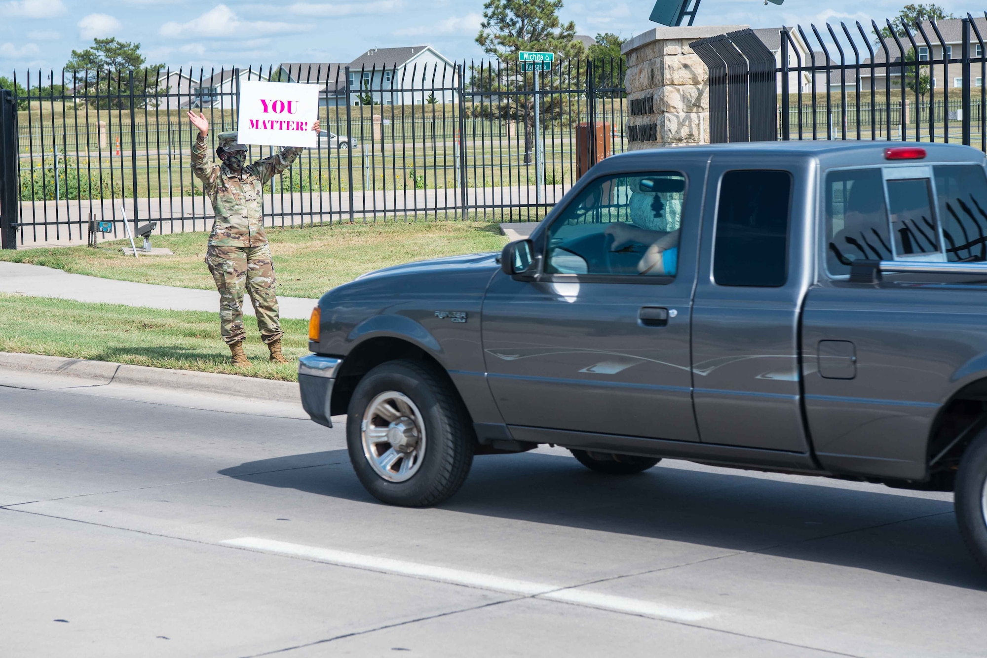 Airman 1st Class Chrishawna Thomas, 22nd Operational Medical Readiness Squadron public health technician, holds an inspirational sign Sept. 1, 2020, at McConnell Air Force Base, Kansas. Members of McConnell’s League of Extraordinary Airmen stood outside of the gates to show support to Team McConnell during National Suicide Prevention Month. (U.S. Air Force photo by Senior Airman Alexi Bosarge)