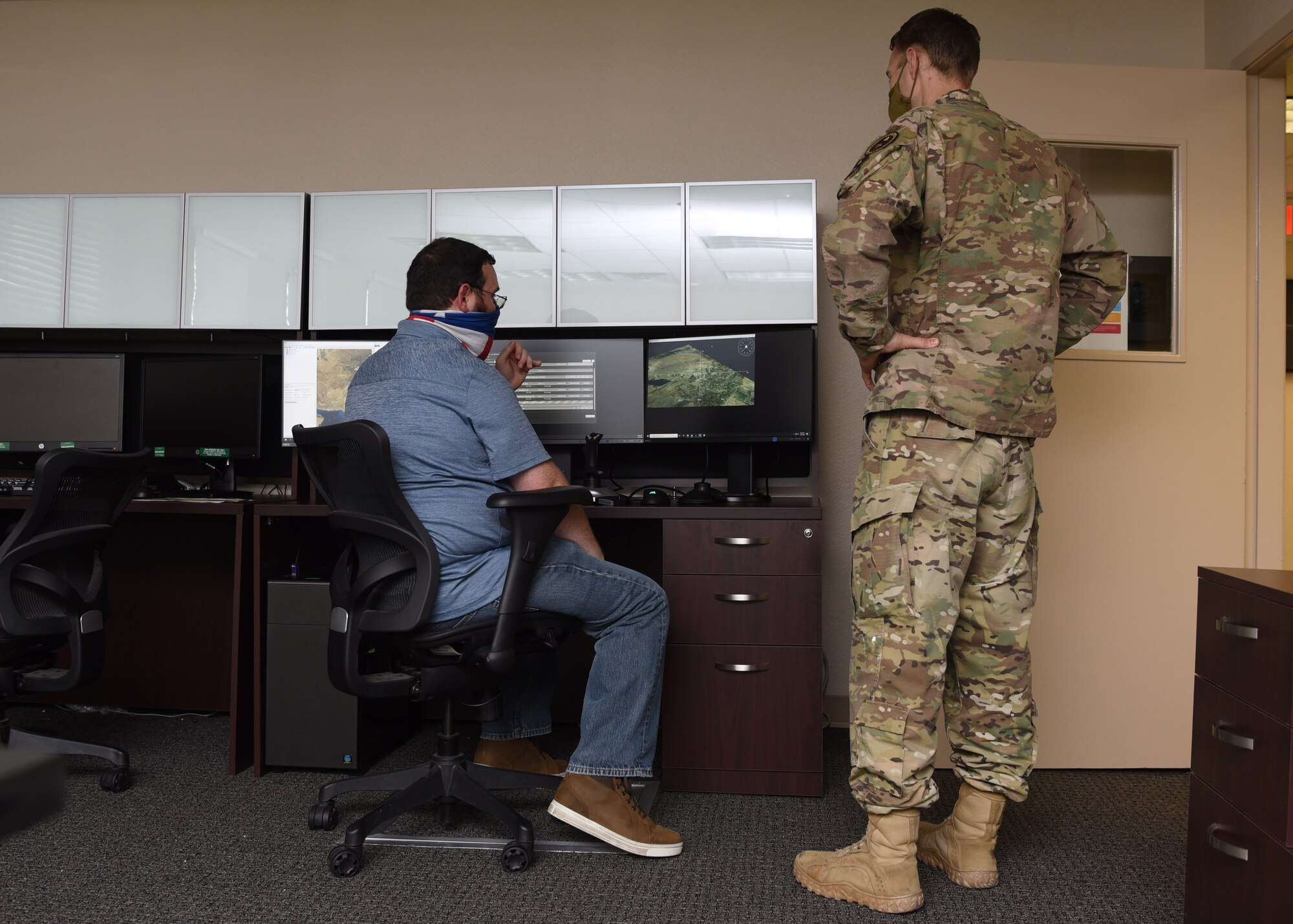 U.S Air Force members of the 313th Training Squadron discuss various simulation capabilities available in the virtual training domain, at the International Intelligence Training Center on Goodfellow Air Force Base, Texas, July 29, 2020. The intelligence training was customized for an international training audience and provided virtual views from airborne intelligence, surveillance and reconnaissance platforms. (U.S Air Force photo by Airman 1st Class Abbey Rieves)