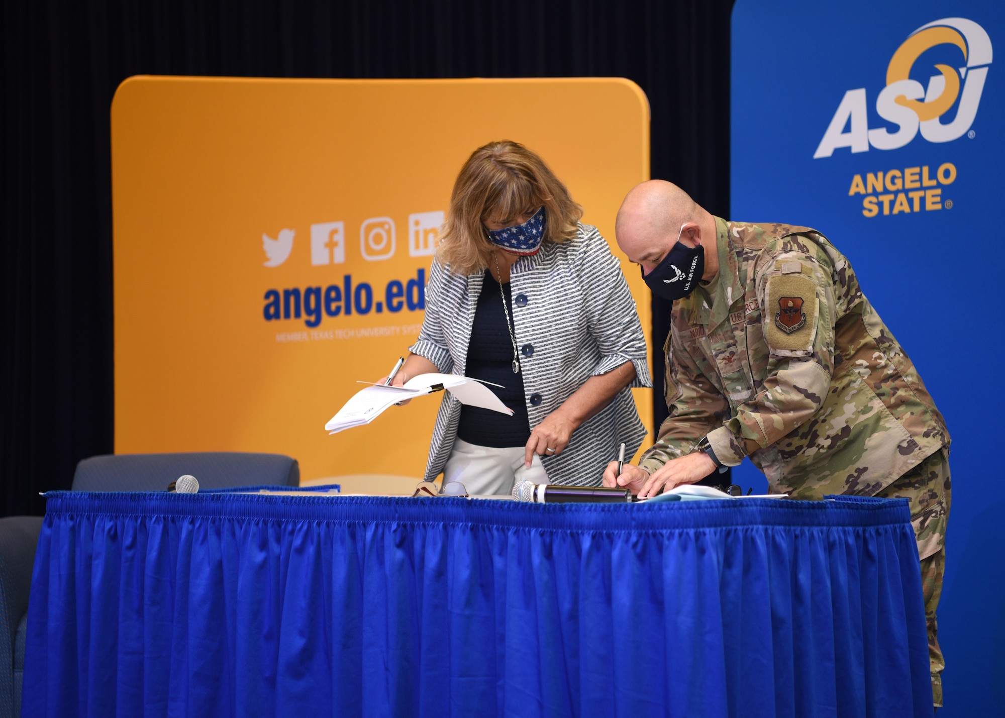 Angelo State University Interim President, Angie Wright supports U.S. Air Force Col. Andres Nazario, 17th Training Wing commander, signing two intergovernmental support agreements, at ASU’s Houston Harte University Center in San Angelo, Texas, Aug. 21, 2020. The first agreement, the Doolittle Scholars Program, which provided faculty development scholarship for Goodfellow instructors, and Contracted Quarters IGSA, which will provide living quarters, food service and the use of the recreation center for Goodfellow’s technical training students, were the first of its kind the base and local community. (U.S. Air Force photo by Senior Airman Abbey Rieves)