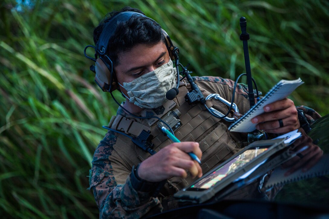 U.S. Marine Corps Sgt. Jose Romo, a joint terminal attack controller assigned to Task Force Ellis, I Marine Expeditionary Force, controls aircraft on station during a close air support exercise at Naval Base Guam on August 17, 2020. Task Force Ellis executed low light/night time close air support training with Helicopter Sea Combat Squadron-25 to integrate joint service partners, increase joint terminal attack controller qualifications and exercise tactical capabilities. (U.S. Marine Corps photo by Sgt. Manuel A. Serrano)