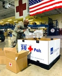 Tech. Sgt. Brison King, non-commissioned officer in charge, Warehouse Operations, Joint Base San Antonio-Lackland, packs critical lab supplies at Port San Antonio, Texas, August 24, 2020.