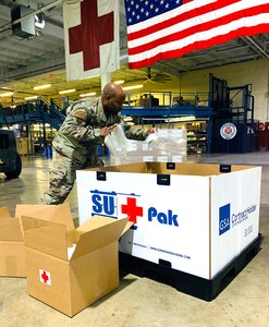 Tech. Sgt. Brison King, non-commissioned officer in charge, Warehouse Operations, Joint Base San Antonio-Lackland, packs critical lab supplies at Port San Antonio, Texas, August 24, 2020.
