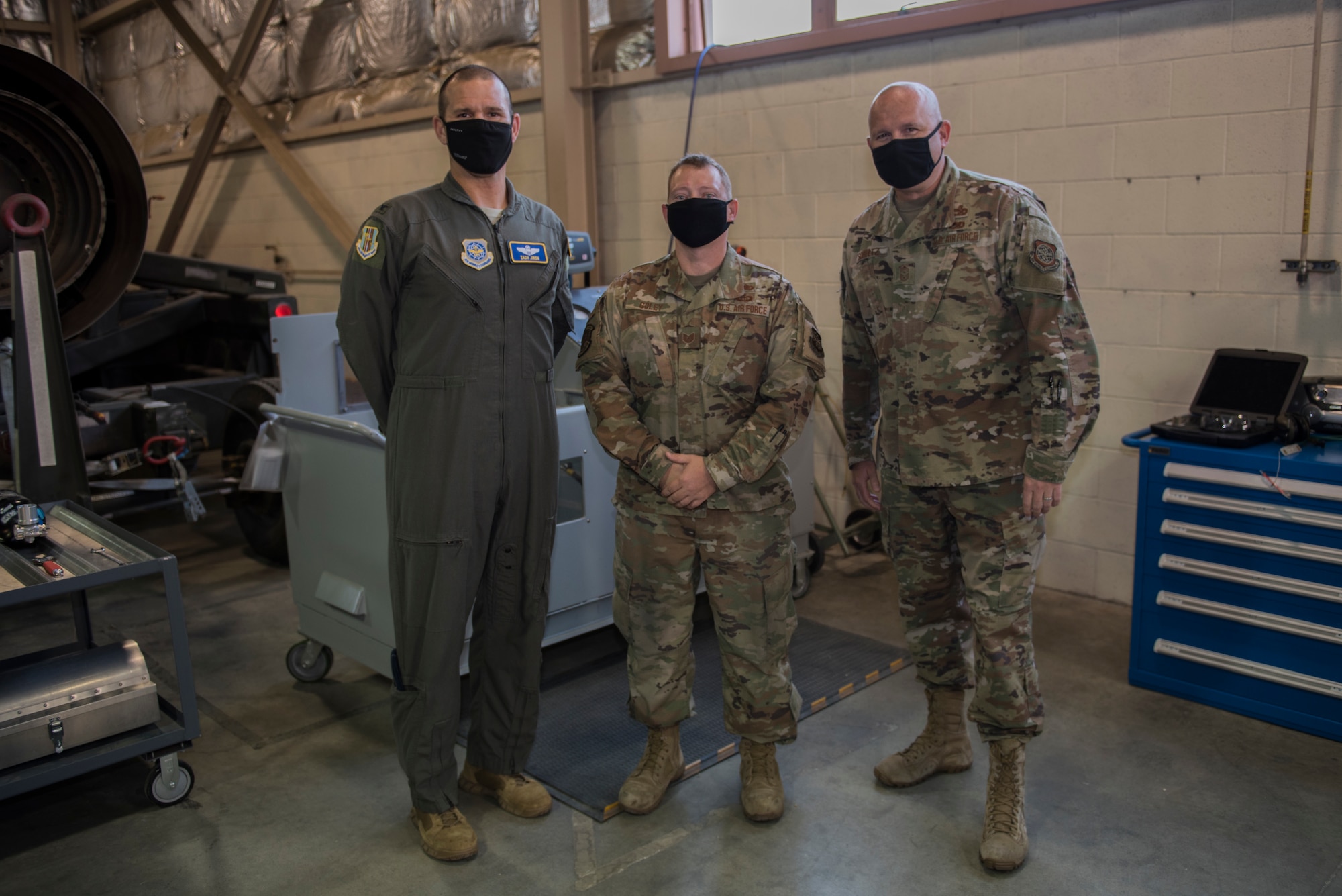 U.S. Air Force Col. Zachery Jiron, left, 60th Air Mobility Wing vice commander, and Chief Master Sgt. Robert Schultz, right, 60th AMW command chief, recognize Tech. Sgt. Charles Goley, 60th Maintenance Squadron aircraft electric and environmental systems craftsman, as a star performer during Leadership Rounds Aug. 28, 2020, at Travis Air Force Base, California. The Leadership Rounds program provides 60th AMW leadership an opportunity to interact with Airmen and get a detailed view of each mission performed at Travis AFB. (U.S. Air Force photo by Senior Airman Cameron Otte)