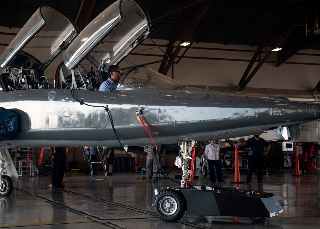 Jaime Villarreal, 12th Maintenance Squadron crew chief, sits inside a T-38 aircraft during a practice transport Aug. 27 at Joint Base San Antonio-Randolph. The T-38 is being pulled by a remotely controlled aircraft towing system designed to make transporting aircraft more cost efficient.