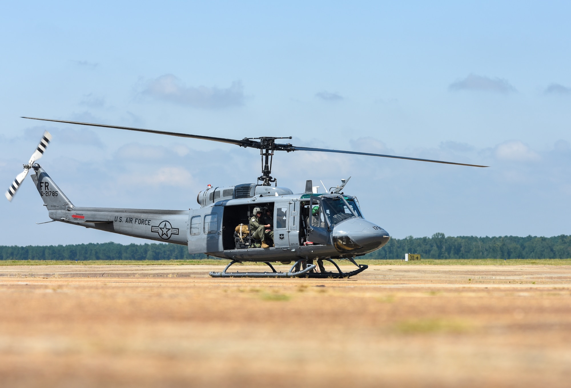 Airmen assigned to the 23rd Flying Training Squadron at Fort Rucker, Alabama land on the flightline in a UH-1N Huey on August 19, 2020, at Columbus Air Force Base, Miss. When configured for passengers, the UH-1N can seat up to 13 people, but actual passenger loads are dependent on fuel loads and atmospheric conditions. (U.S. Air Force photo by Airman 1st Class Davis Donaldson)