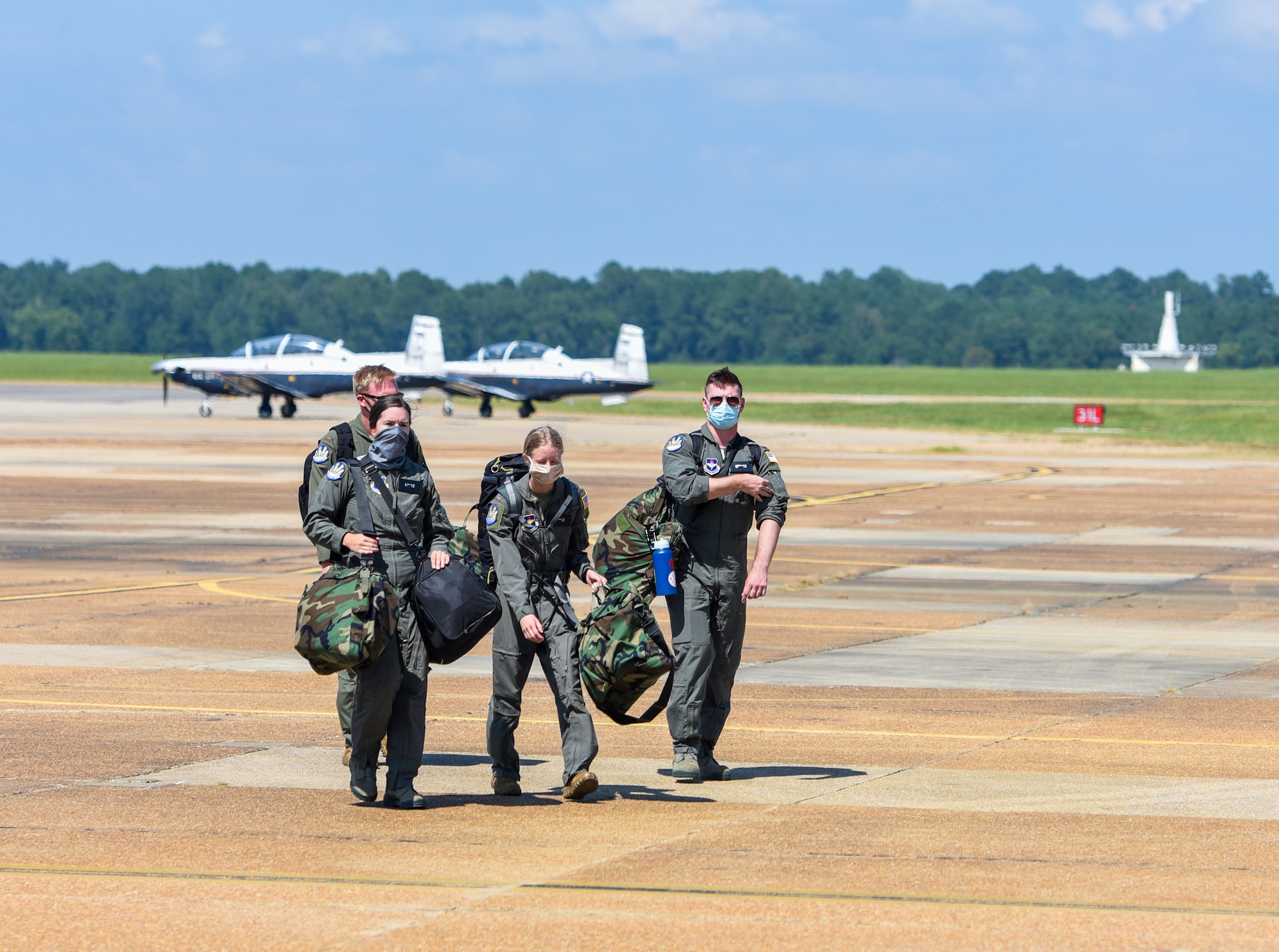 Student pilots assigned to the 23rd Flying Training Squadron at Fort Rucker, Alabama, walk on the flightline at Columbus Air Force Base, Miss. on August 19, 2020. The student pilots came to Columbus AFB to complete the Initial Physiological Training Course. (U.S. Air Force photo by Airman 1st Class Davis Donaldson)