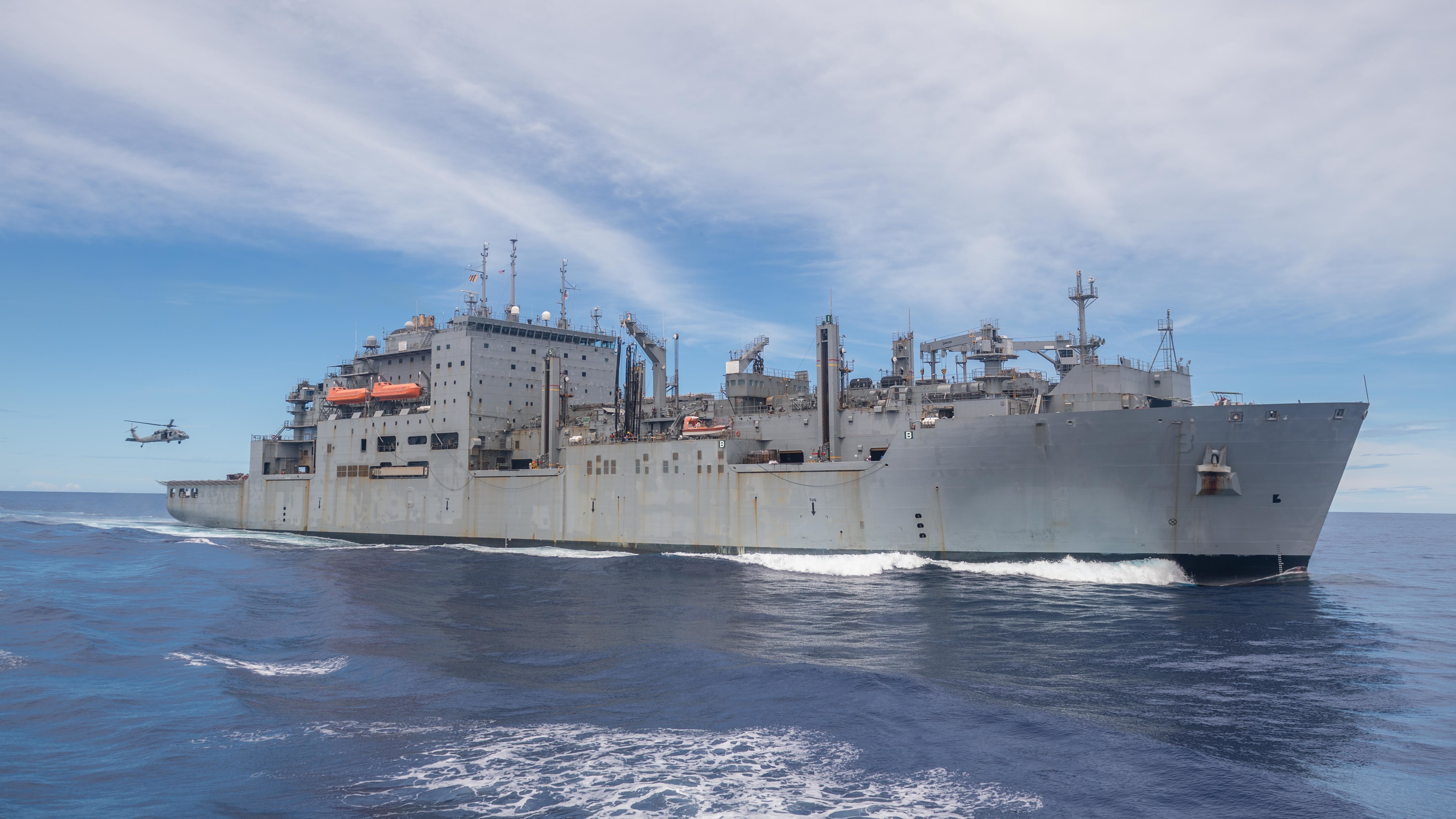 An MH-60S Sea Hawk, assigned to the Ticonderoga-class guided-missile cruiser USS Antietam (CG 54), approaches the Lewis and Clark-class dry cargo and ammunition ship USNS Alan Shepard (T-AKE 3).