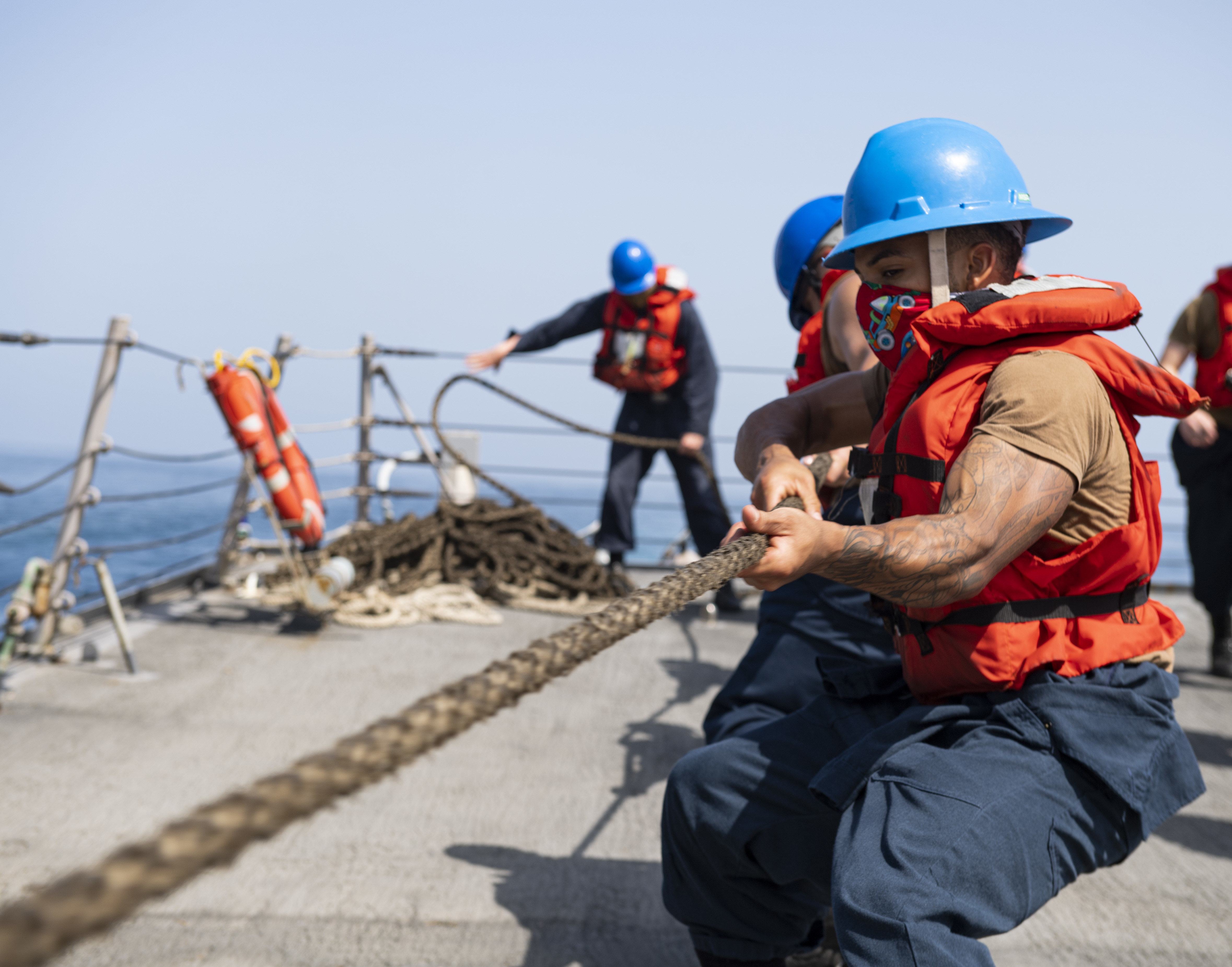 Sonar Technician (Surface) 2nd Class Kailyn Phillips, from Norfolk, Va., heaves around on a line on the forecastle of the Arleigh Burke-class guided-missile destroyer USS Sterett (DDG 104) during a replenishment-at-sea.