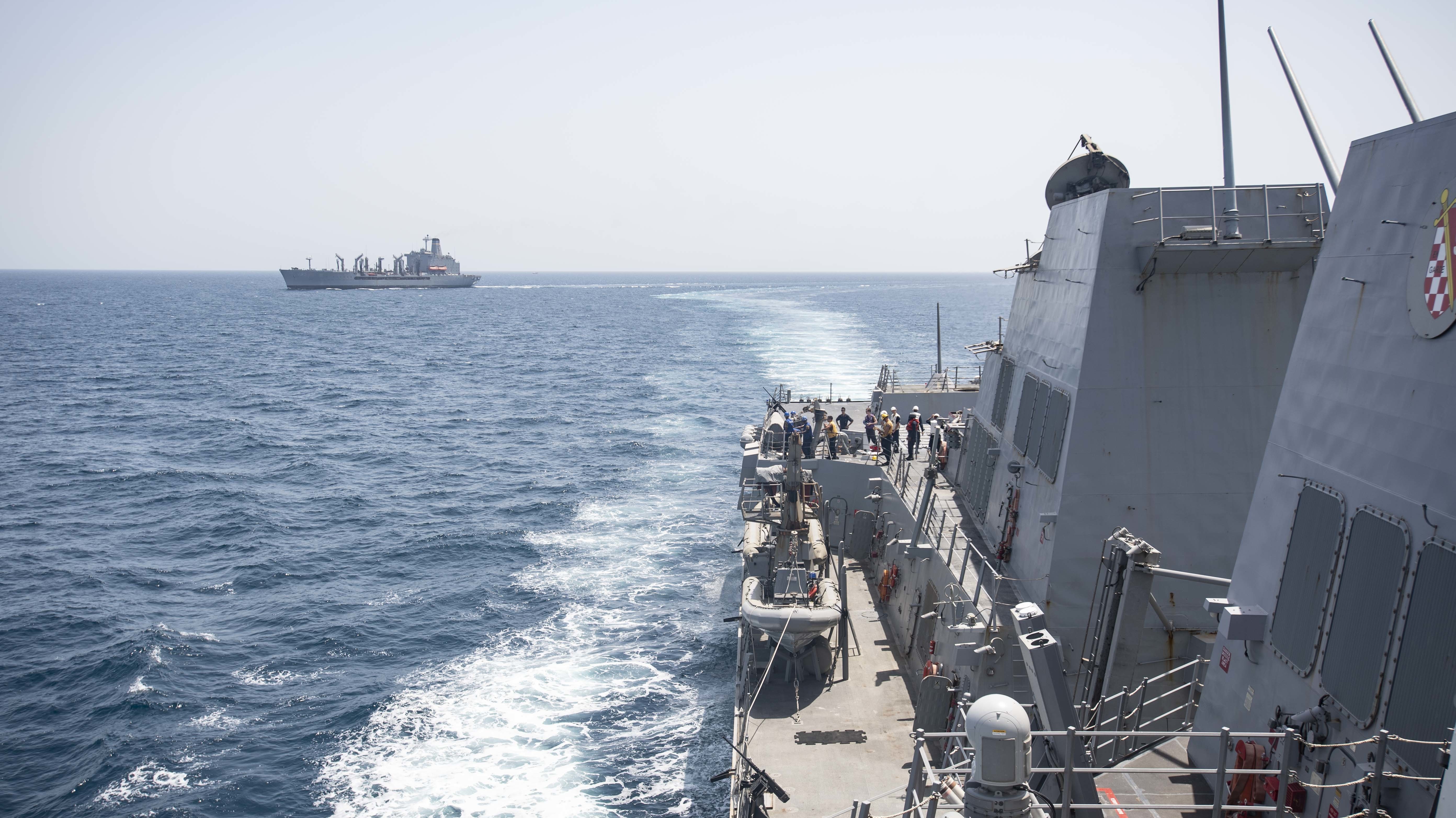 USS Ralph Johnson (DDG 114) steams away from the Military Sealift Command fleet replenishment oiler USNS Leroy Grumman (T-AO 195) after completing a replenishment-at-sea.