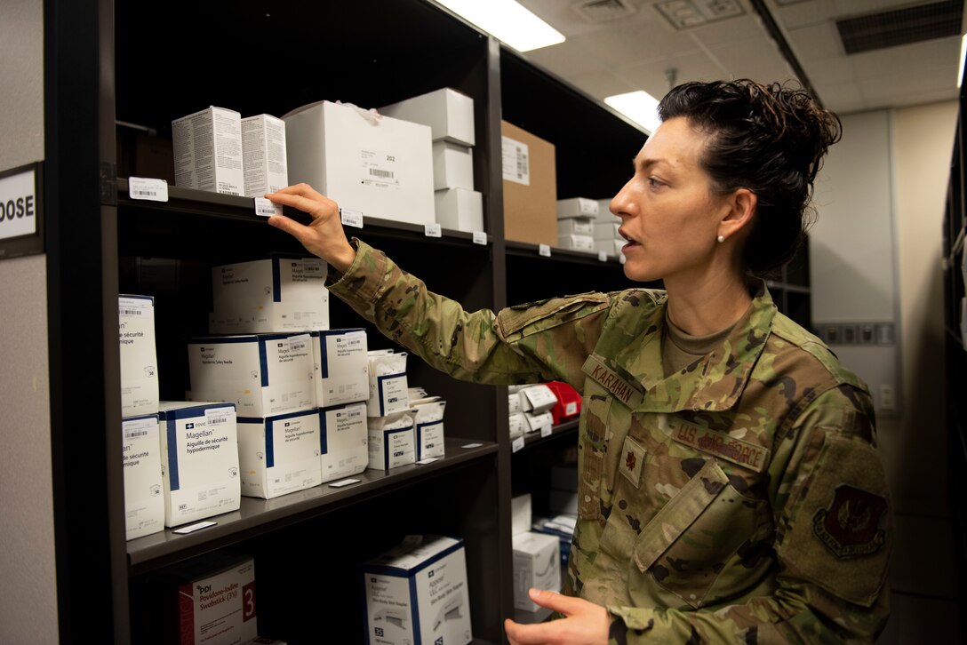 U.S. Air Force Maj. Crystal Karahan, 39th Medical Support Squadron Medical Logistics flight commander, checks the shelf labels in the medical supply storeroom at the base clinic.