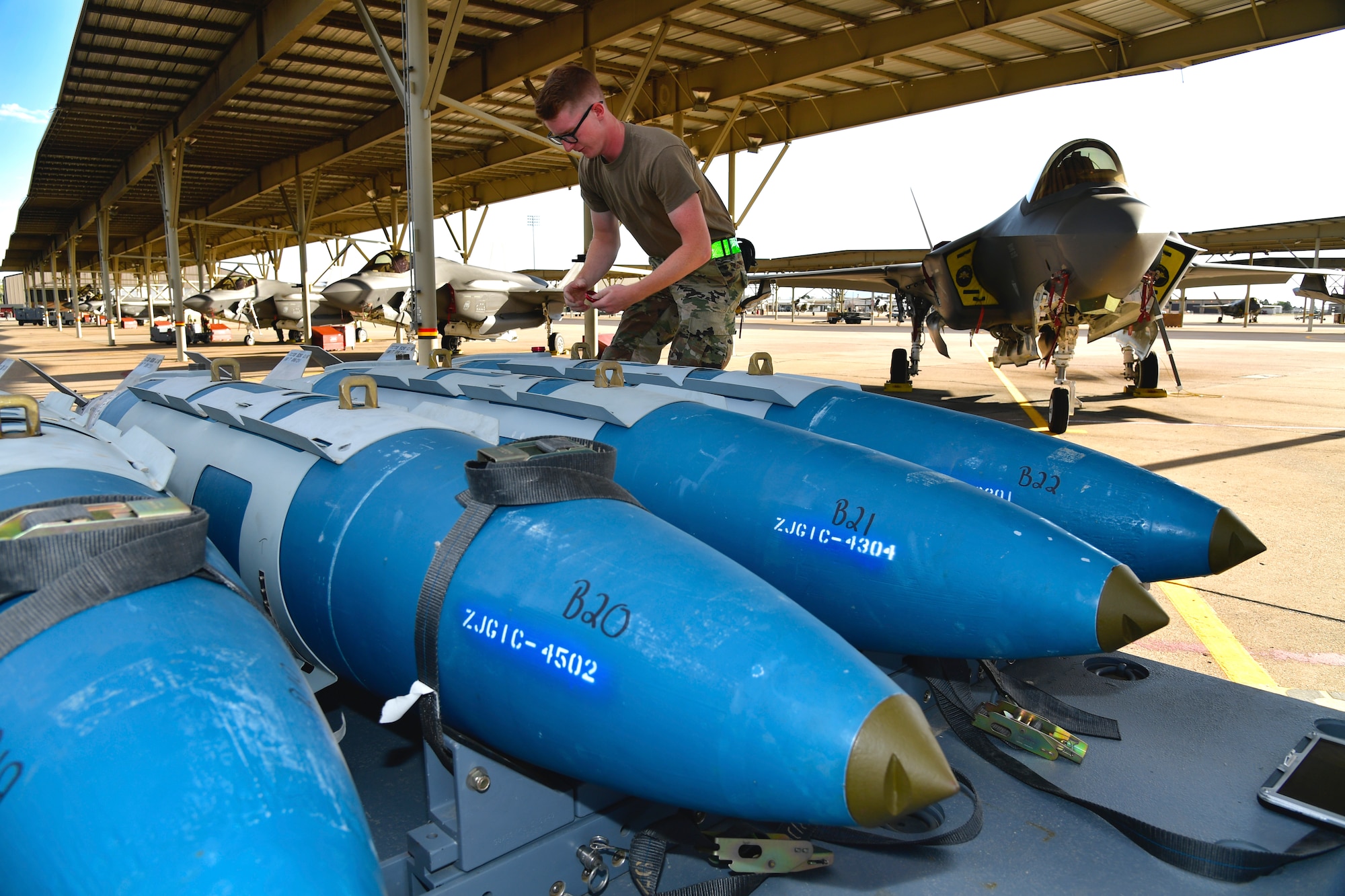 a photo of a weapons load crew