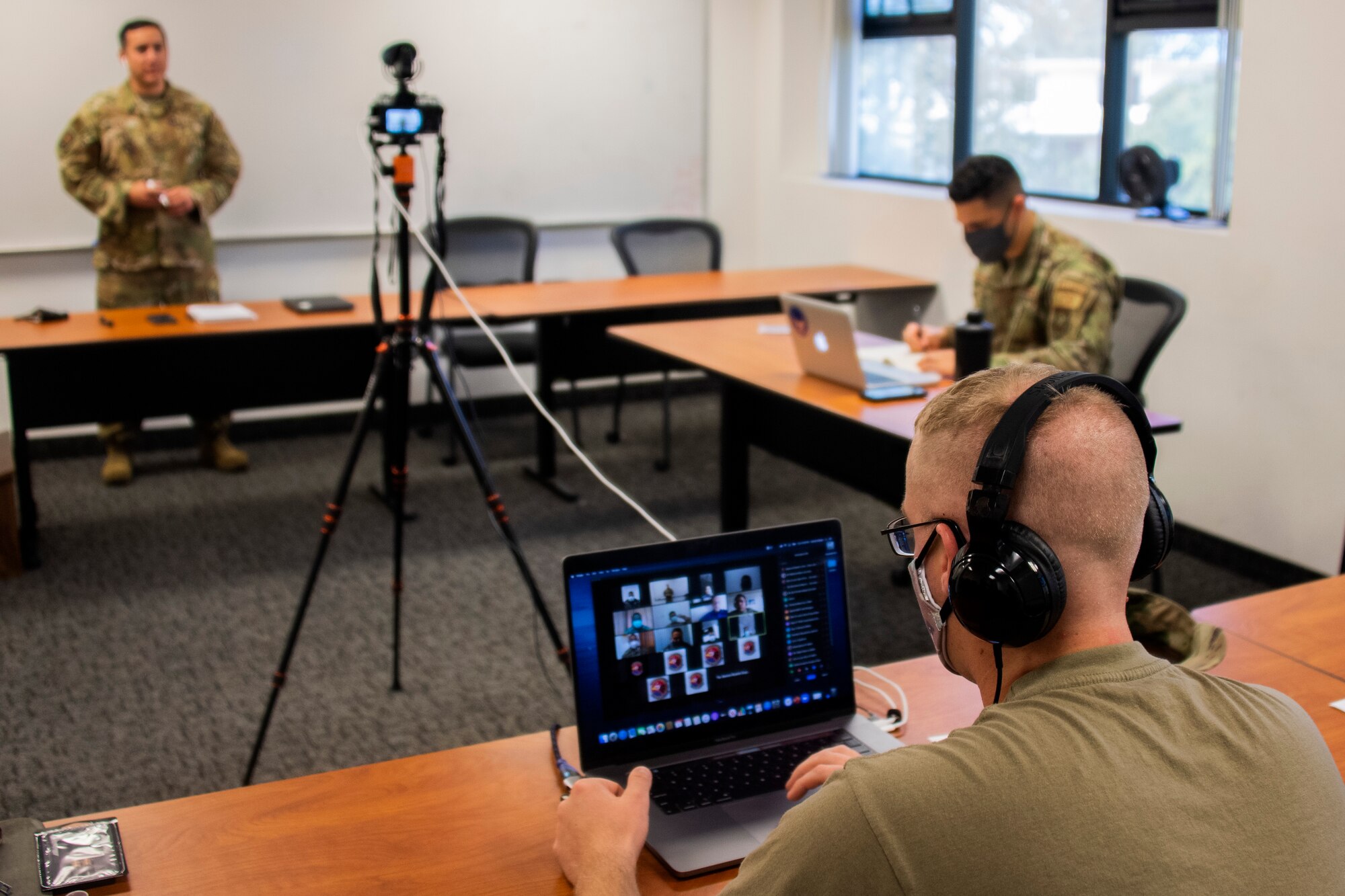 Capt. Matthew Schnarrs, 571st Mobility Support Advisory Squadron course facilitator, observes as Tech. Sgt. Larry Diaz, 571st MSAS instructor, gives a briefing on command and control operations during a virtual engagement with the National Aeronaval Service of Panama Sept. 1, 2020, at Travis Air Force Base in California. The two-week engagement is their first time using a virtual medium to train a partner nation and consists of an introductory command and control course and a multi-topic airfield operations course. (U.S. Air Force photo by Tech. Sgt. Liliana Moreno)