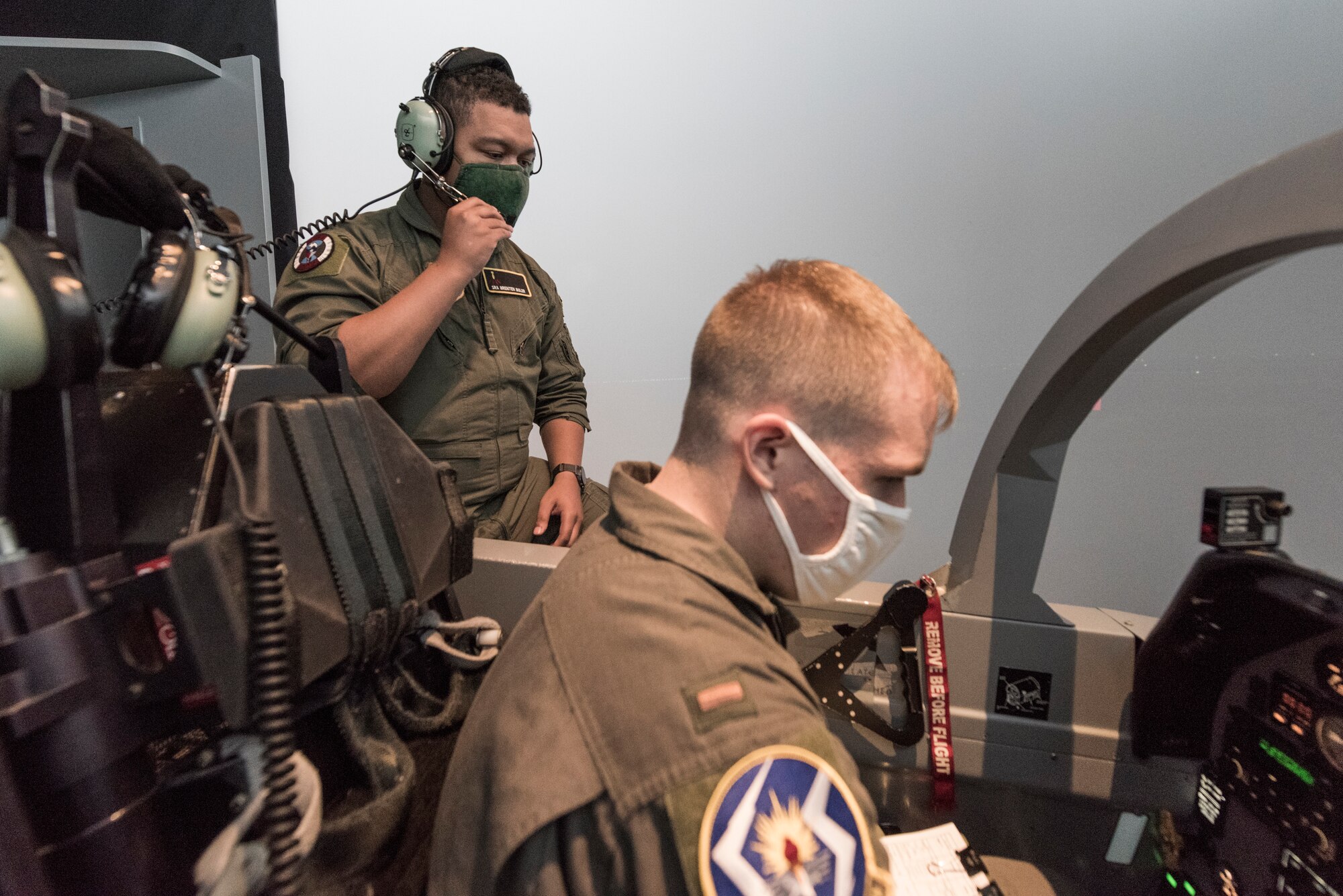 Senior Airman Brenten Boler, 47th Operations Group T-6 simulator instructor, works with 2nd Lt. Chris Summins, 47th Student Squadron student pilot, as he prepares for a flight in the T-6A Texan II simulator, August 31, 2020, at Laughlin Air Force Base, Texas. “I value the job I have now because it gives me the opportunity to pass on the knowledge that I have as a military aviator, as well as an opportunity to work on my own skills and improve my understanding of concepts by teaching them to curious students,” Boler said. “I find the work as an instructor to be incredibly rewarding and enjoy working with the student pilots to help them develop their understanding and skills.” (U.S. Air Force photo by Senior Airman Anne McCready)