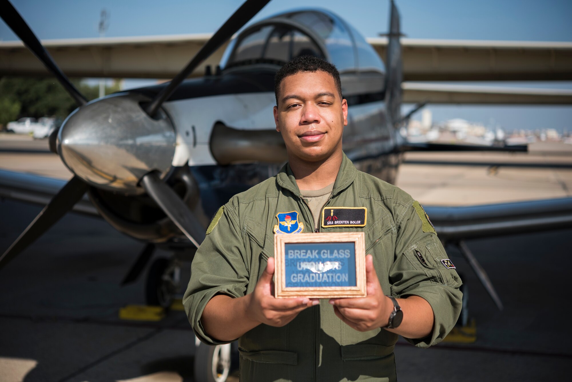 Senior Airman Brenten Boler, 47th Operations Group T-6 simulator instructor, stands on the flightline in front of a T-6A Texan II on August 28, 2020 at Laughlin Air Force Base, Texas. Boler was selected for Pilot Training Next while he was in technical training to become an Air Force linguist, and he graduated pilot training August 31, 2019. (U.S. Air Force photo by Senior Airman Anne McCready)