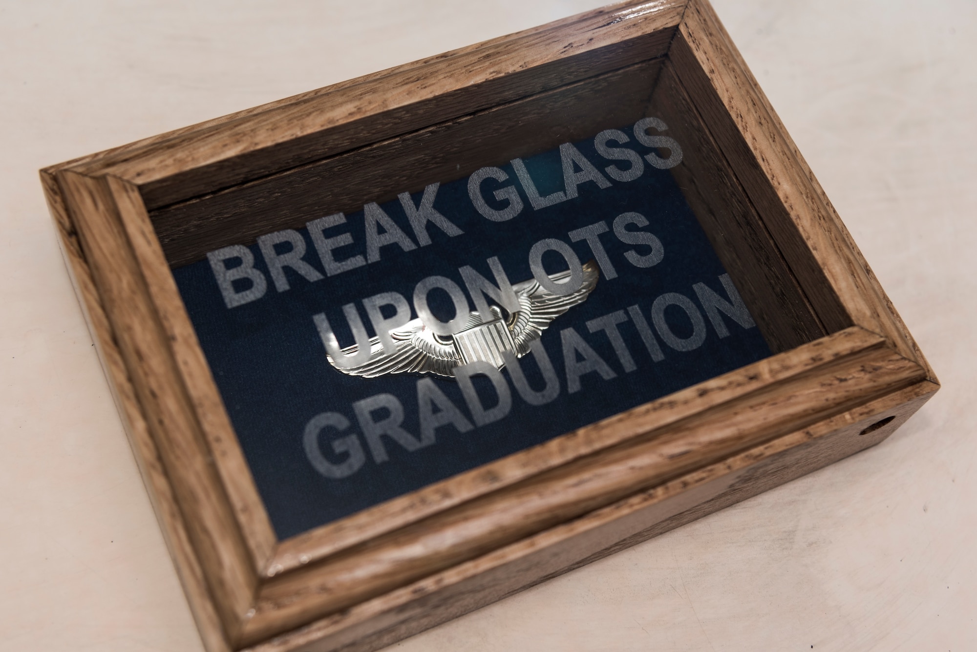 The wings Senior Airman Brenten Boler, 47th Operations Group T-6 simulator instructor, earned upon graduating Pilot Training Next, are displayed on his desk, August 31, 2020, at Laughlin Air Force Base, Texas. Boler plans to finish his degree in December 2020, and he hopes to commission through Office Training School as soon as possible after that so he can break the glass, wear his wings and fly. (U.S. Air Force photo by Senior Airman Anne McCready)