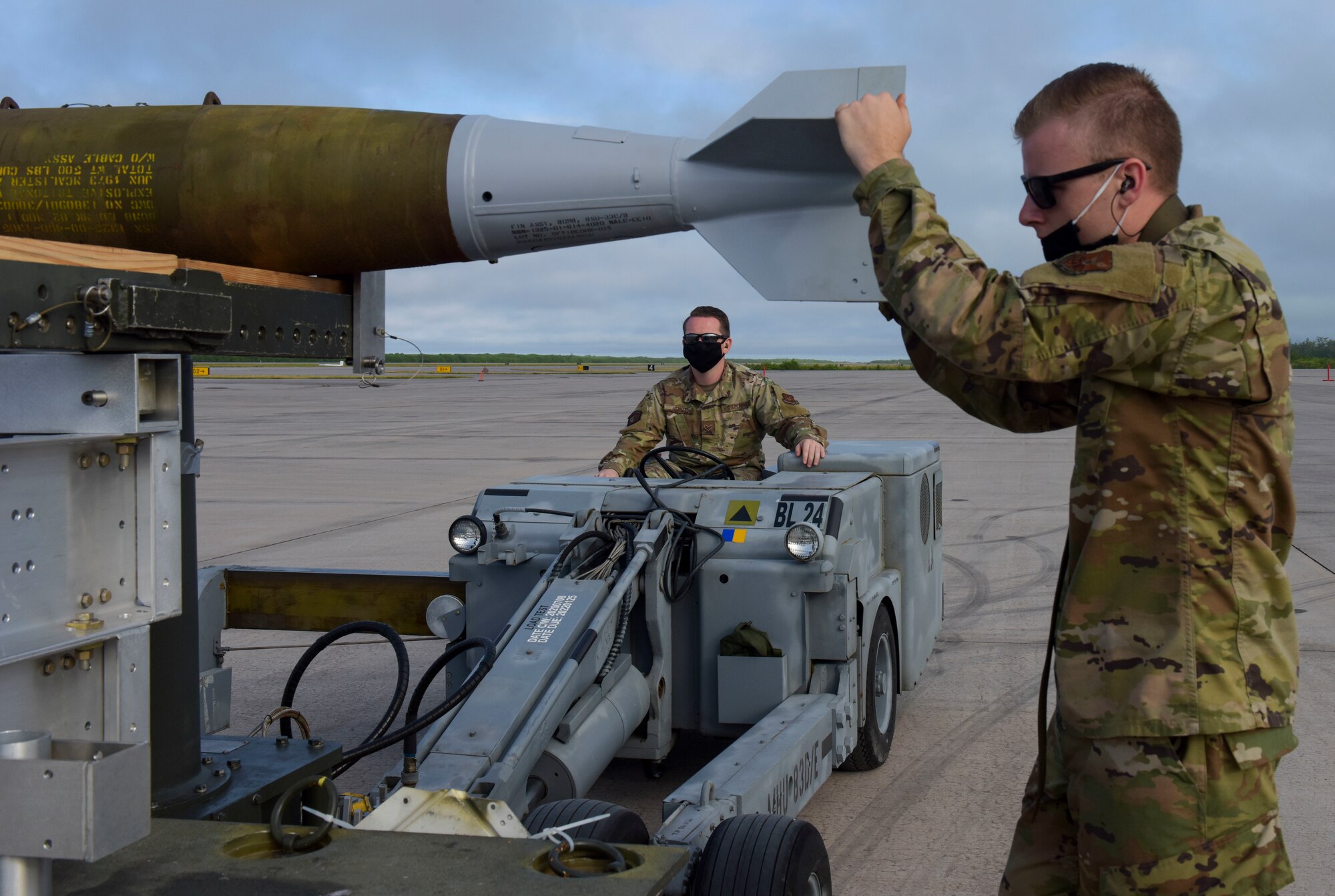 U.S. Air Force Senior Airman Eric Driver (left) and Airman 1st Class William Farrell, 393rd Expeditionary Bomb Squadron weapons load crew members, Whiteman Air Force Base, Missouri, load live weapons for B-2 Spirit Stealth Bomber training at Naval Support Facility Diego Garcia, to support a Bomber Task Force mission, Aug. 13, 2020. They, along with three B-2 Spirit Stealth Bombers as part of a BTF deployment.  As part of their BTF deployment, the B-2s participated in a combined United States-Australia exercise with Marine Rotational Force – Darwin and Australian Defence Forces. (U.S. Air Force photo by Senior Airman Alexandria Lee)