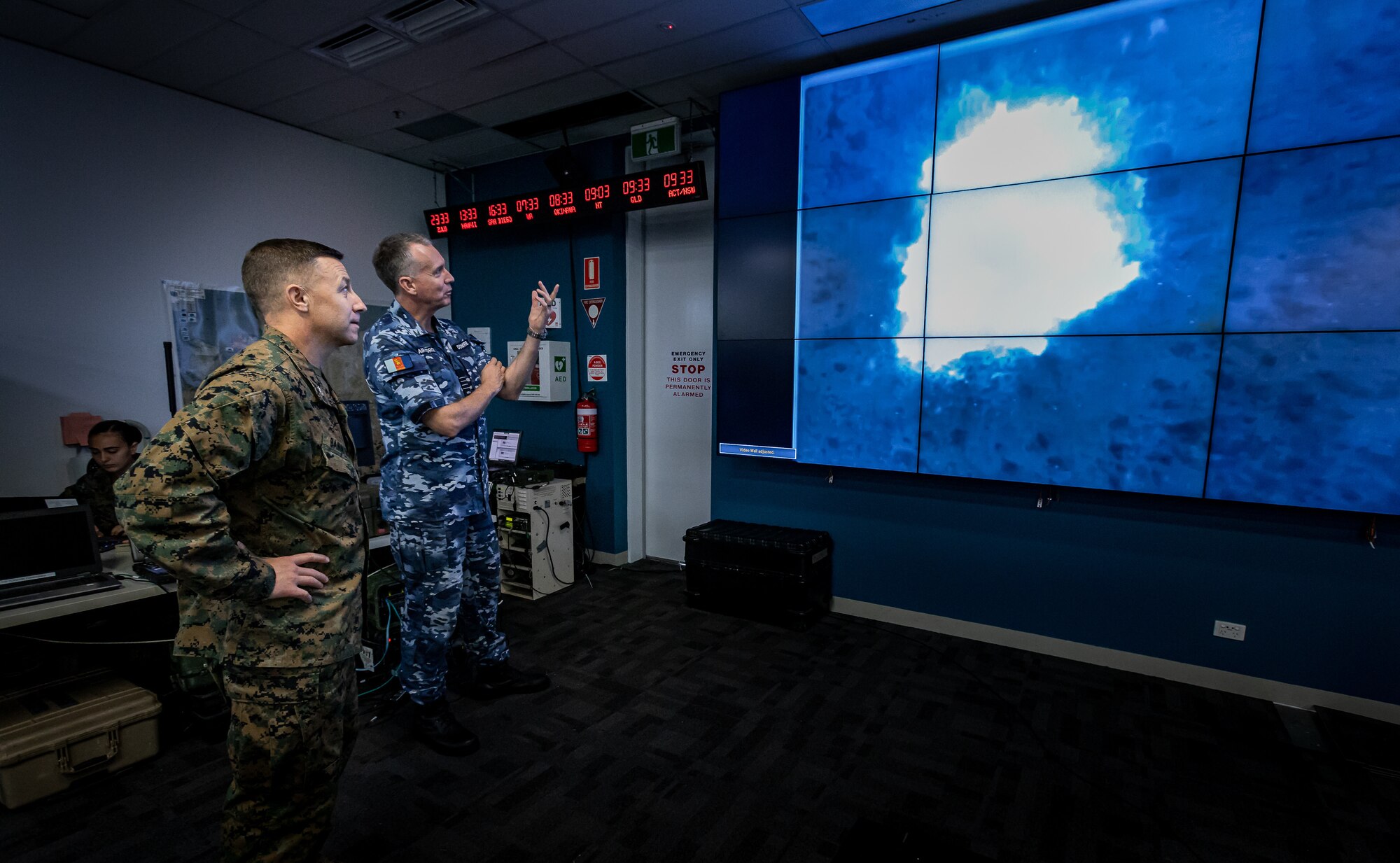 U.S. Marine Corps Col. David M. Banning and Royal Australian Air Force Group Capt. Stewart Dowrie assess footage from a RQ-21A Blackjack taken Aug. 14, 2020, of a B-1B Lancer airstrike. Banning is the commanding officer of Marine Rotational Force – Darwin and Dowrie is the commander of Australian Headquarters Northern Command. The footage was part of a month-long exercise integrating Marine Corps, Australian and U.S. Air Force assets for rapid long distance airstrikes. (U.S. Marine Corps Photo by Gunnery Sgt. Scott M. Schmidt)