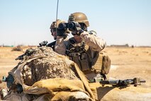 A U.S. Marine with Special Purpose Marine Air-Ground Task Force – Crisis Response – Central Command, and a U.S. Army soldiers with 2nd Brigade Combat Team, 82nd Airborne Division, maintain security during a joint security patrol in Syria, Aug. 23, 2020.