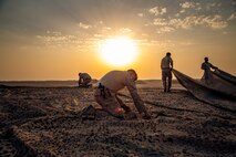 U.S. Marines with Special Purpose Marine Air-Ground Task Force Crisis Response - Central Command 20.2, assemble a camouflage a canopy before a demolition range in Kuwait, Aug. 31, 2020.
