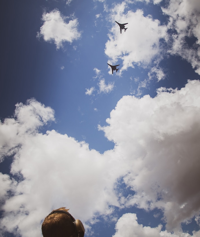 A U.S. Marine Corps forward air controller with Marine Rotational Force - Darwin observes two B-1B Lancers after a successful air strike simulation at Mount Bundey Training Area, Northern Territory, Australia, Aug. 6, 2020. Within the scenario, a combined team of U.S. Marines and Australian Defence Forces provided target information to U.S. Air Force bombers. (U.S. Marine Corps photo by GySgt. Scott M. Schmidt)