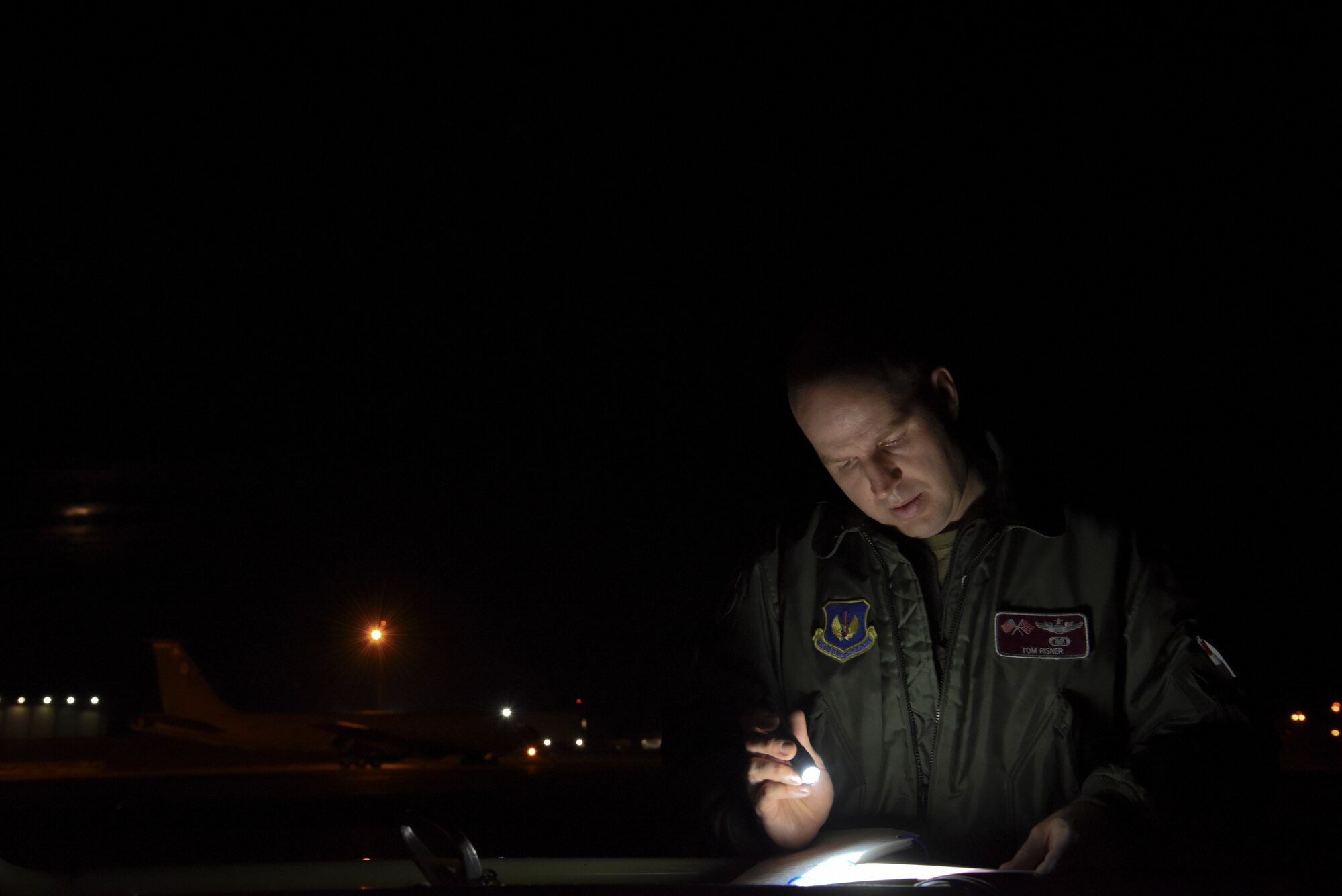 Maj. Thomas Risner, 351st Air Refueling Squadron aircraft commander, reviews a pre-flight checklist prior to a flight supporting a Bomber Task Force mission at RAF Mildenhall, England on Sept. 2, 2020.