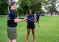 Alexia Fields, center, a poolee with Permanent Contact Station (PCS) Dyersburg, curls a bar alongside Staff Sgt. Brylon N. Shockley, left, a canvassing recruiter, PCS Dyersburg, Recruiting Substation Jackson, Recruiting Station Nashville, during a physical training session with the poolees of PCS Dyersburg, at Dyersburg High School, Dyersburg, Tennessee, Aug. 27, 2020. Poolees participate in physical training sessions with the recruiters to ensure they are physically prepared to endure the challenges of Marine Corps recruit training. Alexia and her older brother Jaquan, back-right, both poolees with PCS Dyersburg, have overcome personal adversity resulting in growth and gained confidence, which further solidified their decisions to join the Marine Corps Delayed Entry Program.