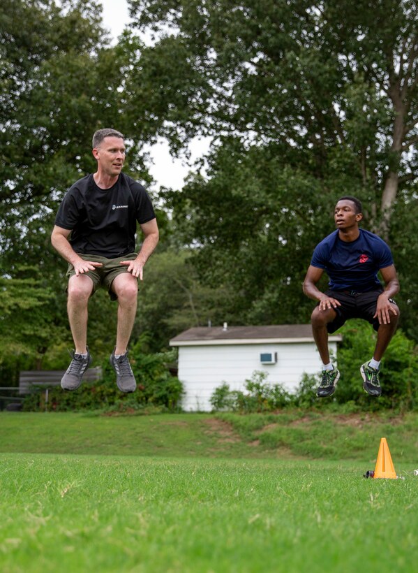 Jaquan Fields, right, a poolee with Permanent Contact Station (PCS) Dyersburg, performs jump tucks alongside Staff Sgt. Brylon N. Shockley, left, a canvassing recruiter, PCS Dyersburg, Recruiting Substation Jackson, Recruiting Station Nashville, during a physical training session with the poolees of PCS Dyersburg, at Dyersburg High School, Dyersburg, Tennessee, Aug. 27, 2020.  Poolees participate in physical training sessions with the recruiters to ensure they are physically prepared to endure the challenges of Marine Corps recruit training. Jaquan and his younger sister Alexia, both poolees with PCS Dyersburg, have overcome personal adversity resulting in growth and gained confidence, which further solidified their decisions to join the Marine Corps Delayed Entry Program.