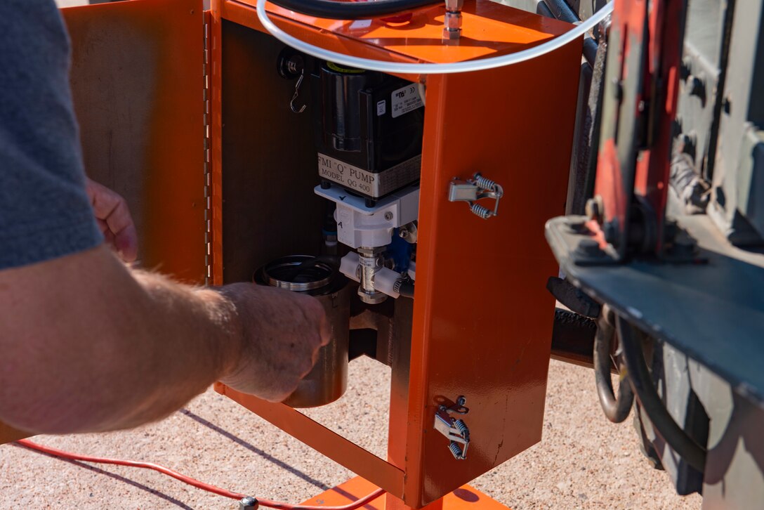 Mark Docter, 711th Human Performance Wing research scientist from Wright-Patterson Air Force Base, Ohio, prepares a pump on the flightline at Dyess AFB, Texas, Aug. 26, 2020.