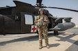 Sgt. Kayla Sampson stands in front of a UH-60 Black Hawk Helicopter while stationed in Camp Buehring, Kuwait on July 30, 2020. As a flight medic with Charlie Company, 2-238th General Aviation Support Battalion, Sampson performs all in-flight medical attention to patients during transport.