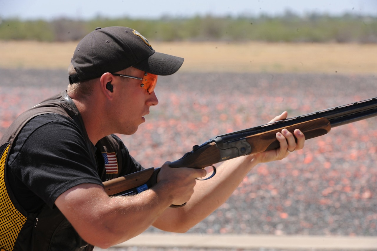A man aims a shotgun.