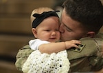 Spc. Dallas Ochoa, assigned to the 2nd Infantry Brigade Combat Team, 4th Infantry Division, reunites with his daughter, Kaylynn, following a homecoming ceremony at William Bill Reed Special Event Center, Fort Carson, Colorado, Nov. 13, 2018.
