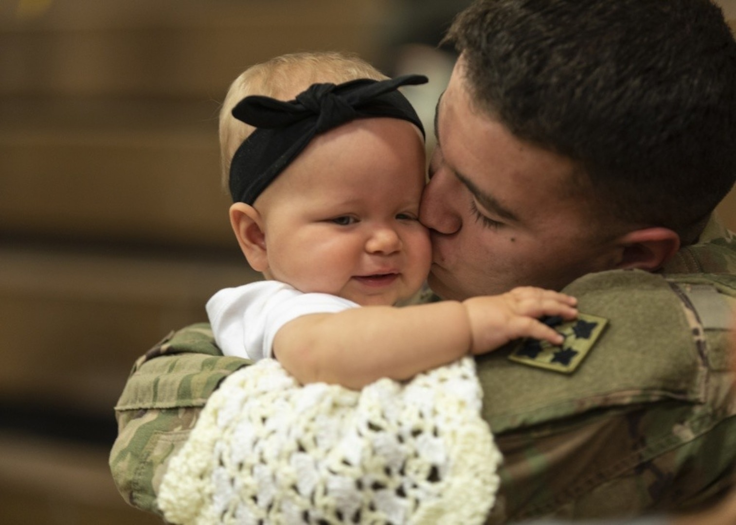 Spc. Dallas Ochoa, assigned to the 2nd Infantry Brigade Combat Team, 4th Infantry Division, reunites with his daughter, Kaylynn, following a homecoming ceremony at William Bill Reed Special Event Center, Fort Carson, Colorado, Nov. 13, 2018.