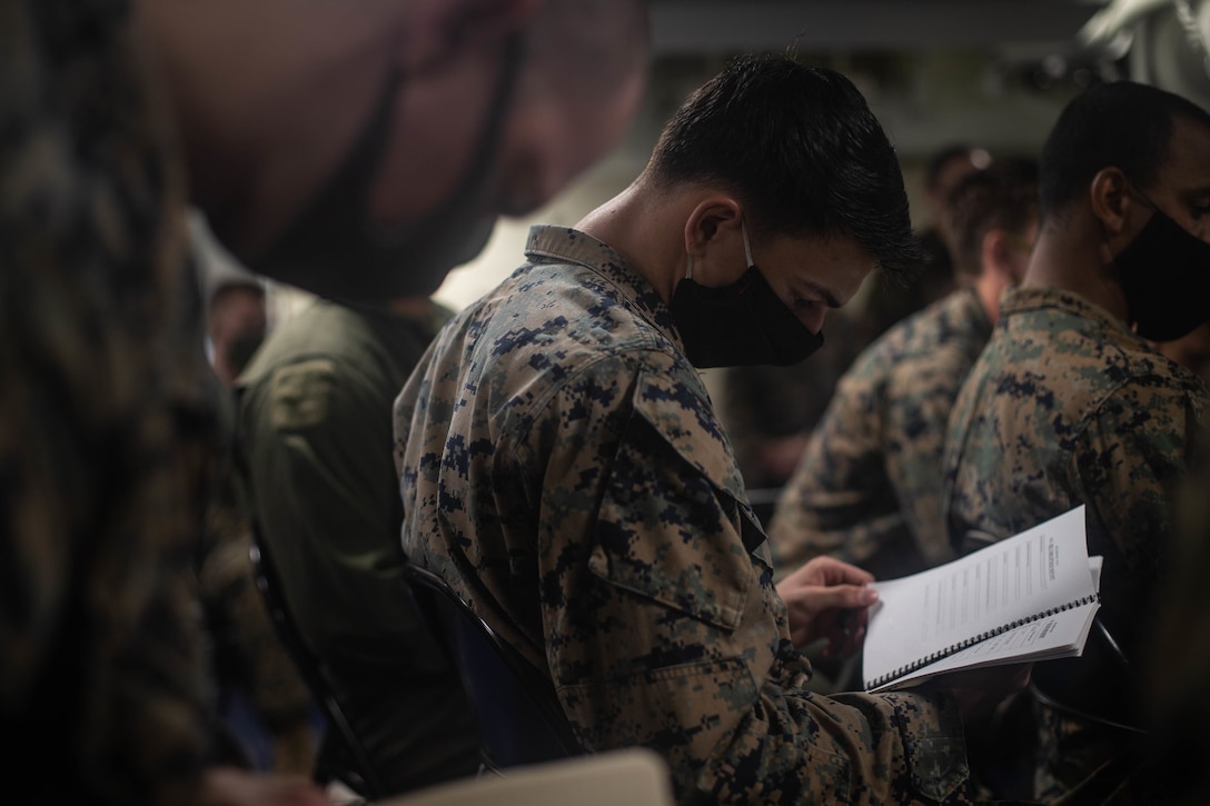 A U.S. Marine looks at a standard operating procedure book during a class aboard USS New Orleans (LPD 18), Aug. 21.