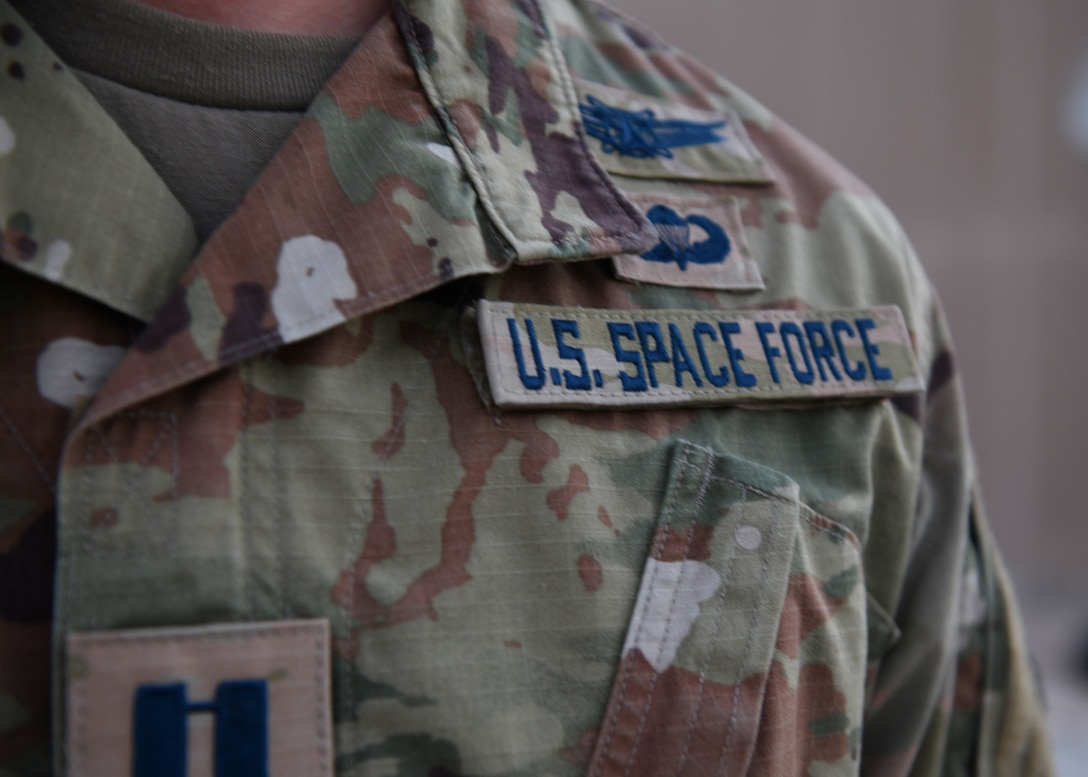 Capt. Ryan Vickers stands for a photo to display his new service tapes after taking his oath of office to transfer from the U.S. Air Force to the U.S. Space Force on Sept. 1, 2020, at Al Udeid Air Base, Qatar. The Space Force is the United States' newest service in more than 70 years. (U.S. Air Force photo by Staff Sgt. Kayla White)