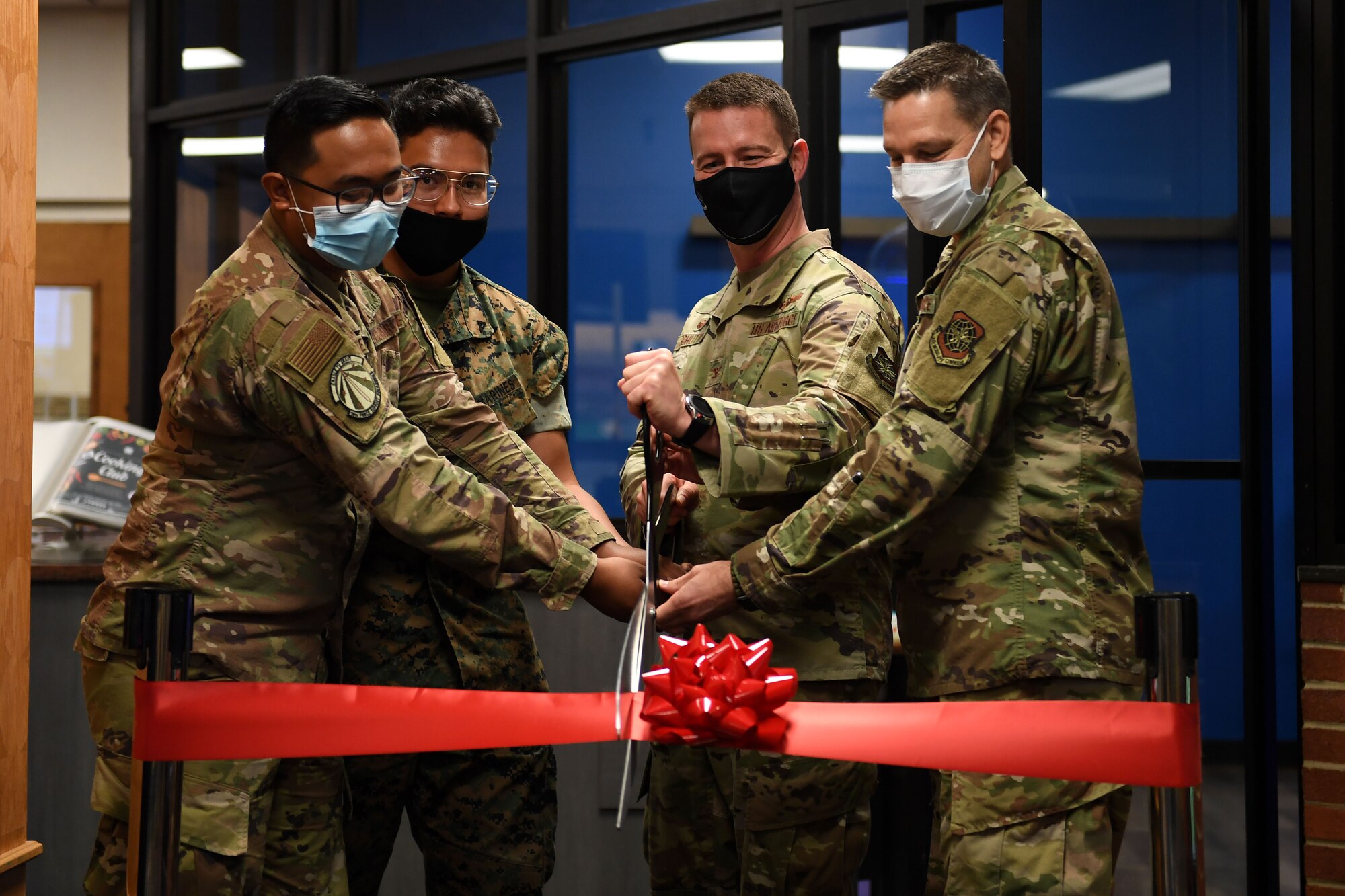 Men cut a ribbon.