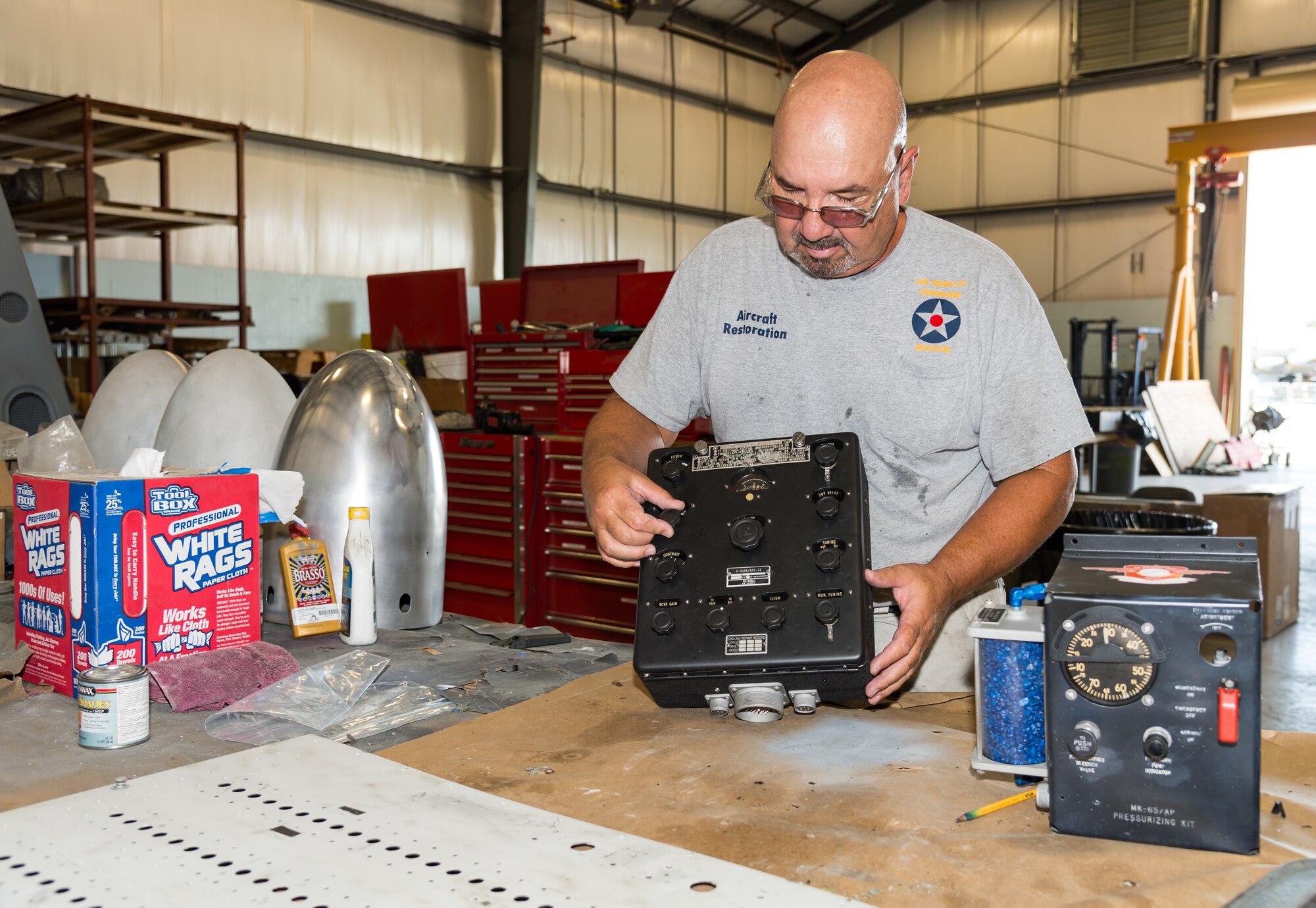 Air Mobility Command Museum restoration volunteer Randy Kroegman looks at a Boeing KB-50J radar component, Sept. 3, 2020, in the AMC Museum restoration hangar on Dover Air Force Base, Delaware. Of the 130 volunteers that work at the museum, only 15 non-vulnerable volunteers under the age of 65 are allowed to work under the base’s current health protection guidelines for, which align with those established by the state of Delaware and federal government. (U.S. Air Force photo by Roland Balik)