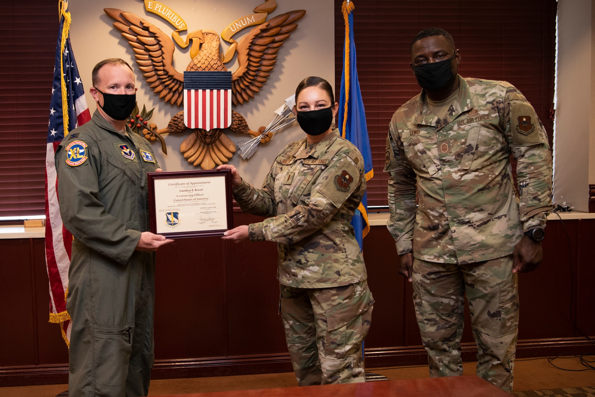 Col. Craig D. Prather, 47th Flying Training Wing commander, and Chief Master Sgt. Brian Lewis, 47th Operations Group superintendent, present a certificate of appointment as a contracting officer to 2nd Lt. Candice Arcuri, 47th Contracting Flight contracting officer, at Laughlin Air Force Base, Texas, Aug. 31, 2020. Prior to arriving at Laughlin, Arcuri was stationed at Nellis Air Force Base, Nev. where she served as a warranted contracting officer, but her warrant was deactivated due to her departure for Officer Training School. (U.S. Air Force photo by Senior Airman Marco A. Gomez)