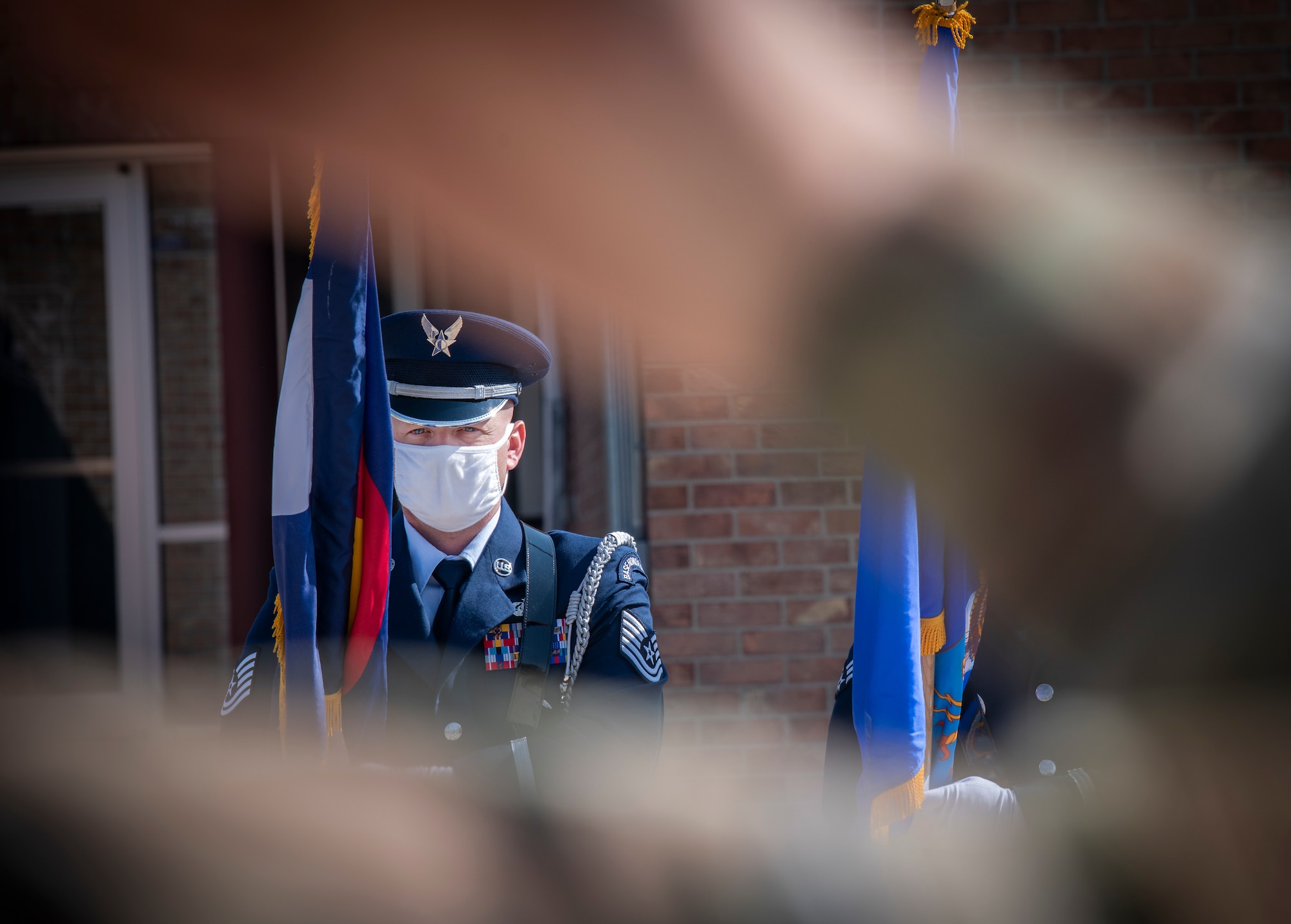 Tech. Sgt. Daniel Thurman, High Frontier Honor Guard ceremonial guardsman, presents a flag during the graduation ceremony Sept. 1, 2020, at Peterson Air Force Base, Colorado. The ceremony recognized 17 Airmen who completed the training. (U.S. Air Force photo by Airman 1st Class Jonathan Whitely)