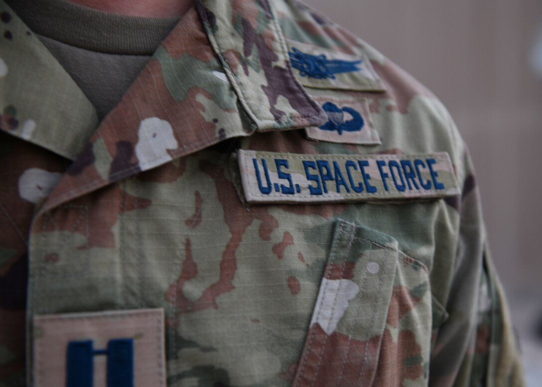 Capt. Ryan Vickers stands for a photo to display his new service tapes after taking his oath of office to transfer from the U.S. Air Force to the U.S. Space Force on Sept. 1, 2020, at Al Udeid Air Base, Qatar. The Space Force is the United States' newest service in more than 70 years. (U.S. Air Force photo by Staff Sgt. Kayla White)