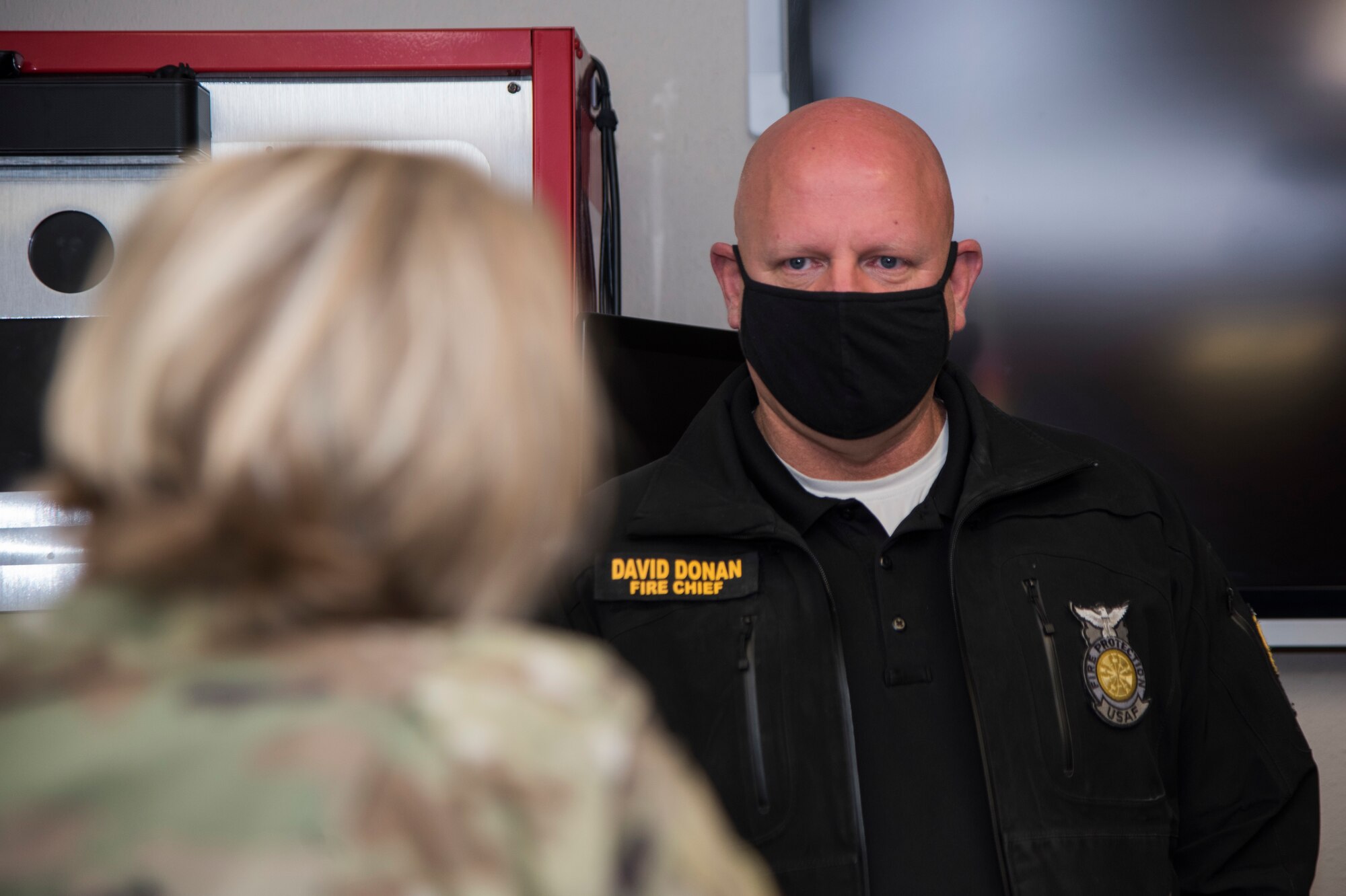 David Donan, 673d Civil Engineer Squadron fire chief, explains how the Joint Base Elmendorf-Richardson Fire and Emergency Services Flight support the 673d Air Base Wing during an immersion tour at JBER, Alaska, Aug. 28, 2020. U.S. Air Force Col. Kirsten Aguilar, JBER and 673d ABW commander, focused on the 673d CES Airmen and their role in supporting the joint base partnership on the installation in her tour.