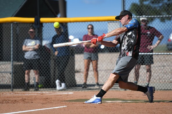 Bryan Scroggs, 4th Space Operations Squadron, hits the ball into play during the softball championship against the U.S. Air Force Warfare Center Sept. 2, 2020, at Schriever Air Force Base, Colorado. The 4th SOPS earned the championship after a 15-12 win in game one against the USAFWC and 17-11 in the finale. (U.S. Air Force photo by Dennis Rogers)
