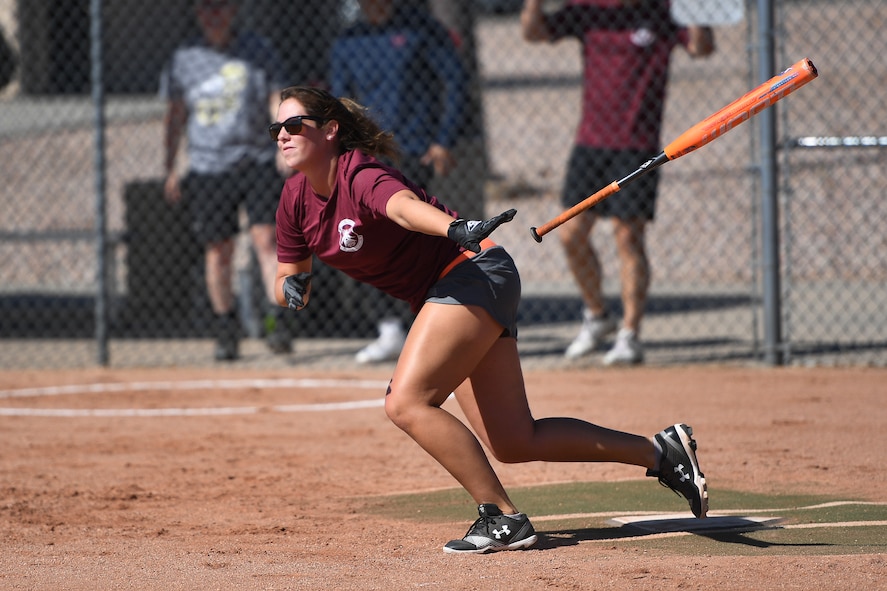 Meghan Moore, 4th Space Operations Squadron, drops her bat following a hit during the softball championship game against U.S. Air Force Warfare Center Sept. 2, 2020, at Schriever Air Force Base, Colorado. The 4th SOPS trailed in both contests against the USAFWC but managed comeback victories in both to win the title. (U.S. Air Force photo by Dennis Rogers)