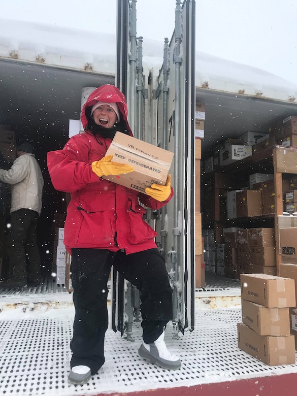 Capt. Austin Leedy, veterinary food safety officer from Public Health Activity-San Diego, carries a box of frozen foods out of a shipping container at Palmer Station, Antarctica, October 2019. U.S. Army Public Health Command-Pacific veterinary food safety officers partner with the National Science Foundation to ensure Palmer Station has a safe food supply and to perform independent food inspections throughout the entire annual resupply process. (Courtesy photo)