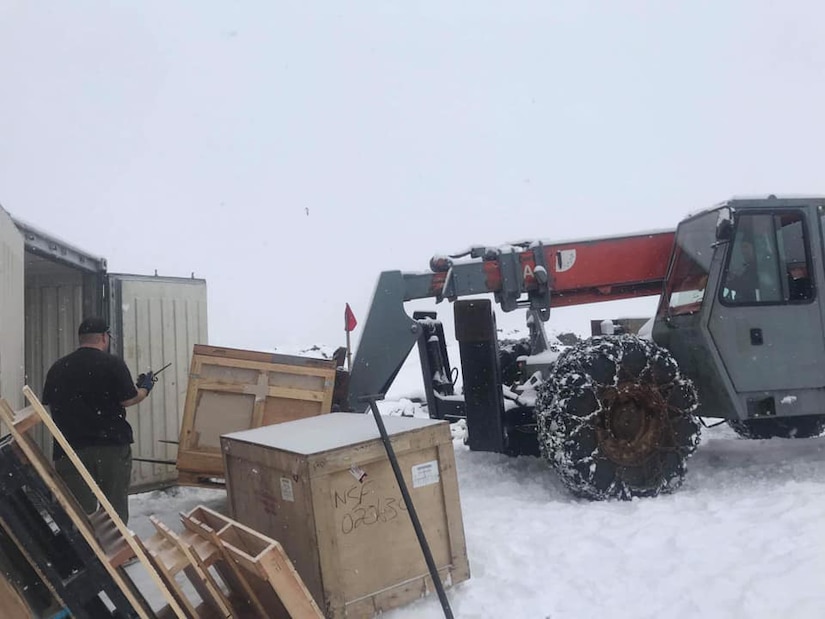 Workers unload crates of food from a shipping container at Palmer Station, Antarctica, October 2019. The crates of food were inspected by U.S. Army Public Health Command-Pacific veterinary food safety officers to ensure the food was safe to eat and that no one stationed at Palmer Station would get sick from foodborne illnesses. (U.S. Army photo by Capt. Austin Leedy)