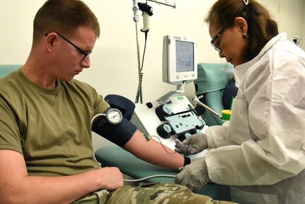 Raquel Duran, Tripler Army Medical Center senior registered nurse, draws blood from the arm of Sgt. Trevor Johnson, noncommissioned officer in charge of the Marine Corps Base Hawaii Veterinary Section, at TAMC, Hawaii, Jan. 16, 2020. Johnson regularly donates blood and platelets to the Armed Service Blood Program. Since 1962, the ASBP has served as the sole provider of blood for the U.S. military. (U.S. Army photo by Amber E. Kurka)