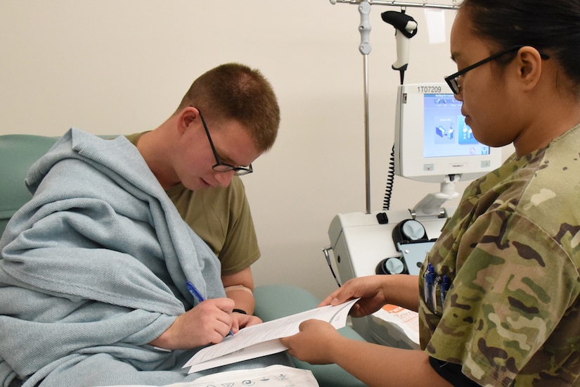 Spc. Jasnine Montana, Tripler Army Medical Center laboratory technician, has Sgt. Trevor Johnson, noncommissioned officer in charge of the Marine Corps Base Hawaii Veterinary Section, fill out consent forms to donate blood platelets to the Armed Service Blood Program at TAMC, Hawaii, Jan. 16, 2020. Johnson is O positive, and tries to donate blood to the ASBP as often as he can. The ASBP reports that 84 percent of the U.S. population has Rh positive blood. This means that Soldiers like Johnson can help a large percentage of people who are in need of blood. (U.S. Army photo by Amber E. Kurka)