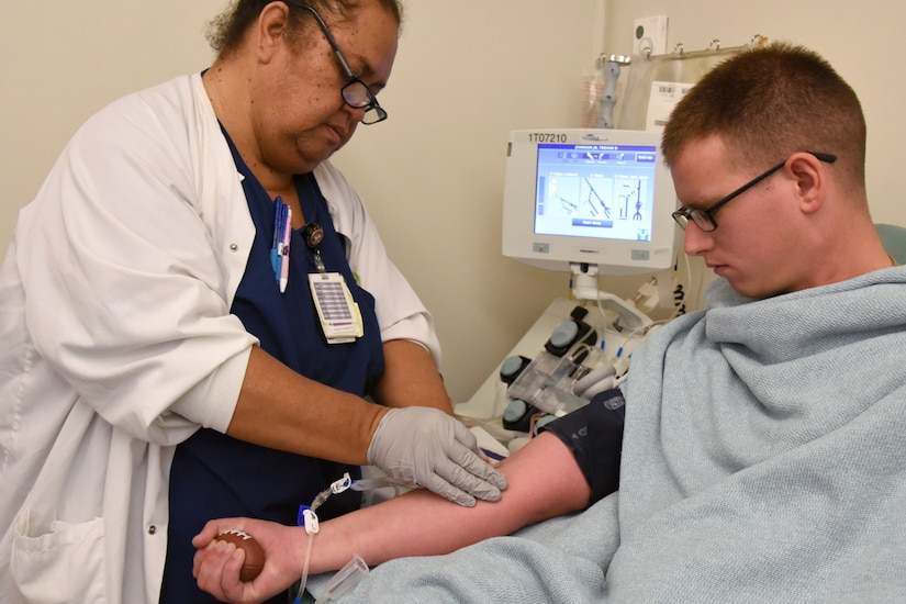 Pone Manoa, Tripler Army Medical Center registered nurse, prepares the arm of Sgt. Trevor Johnson, noncommissioned officer in charge of the Marine Corps Base Hawaii Veterinary Section, to donate blood platelets to the Armed Service Blood Program at TAMC, Hawaii, Jan. 16, 2020. The ASBP is the official blood collection, manufacturing and transfusion program for the U.S. military. The mission of the ASBP is to provide quality blood products and services for all worldwide customers in both peace and war. (U.S. Army photo by Amber E. Kurka)