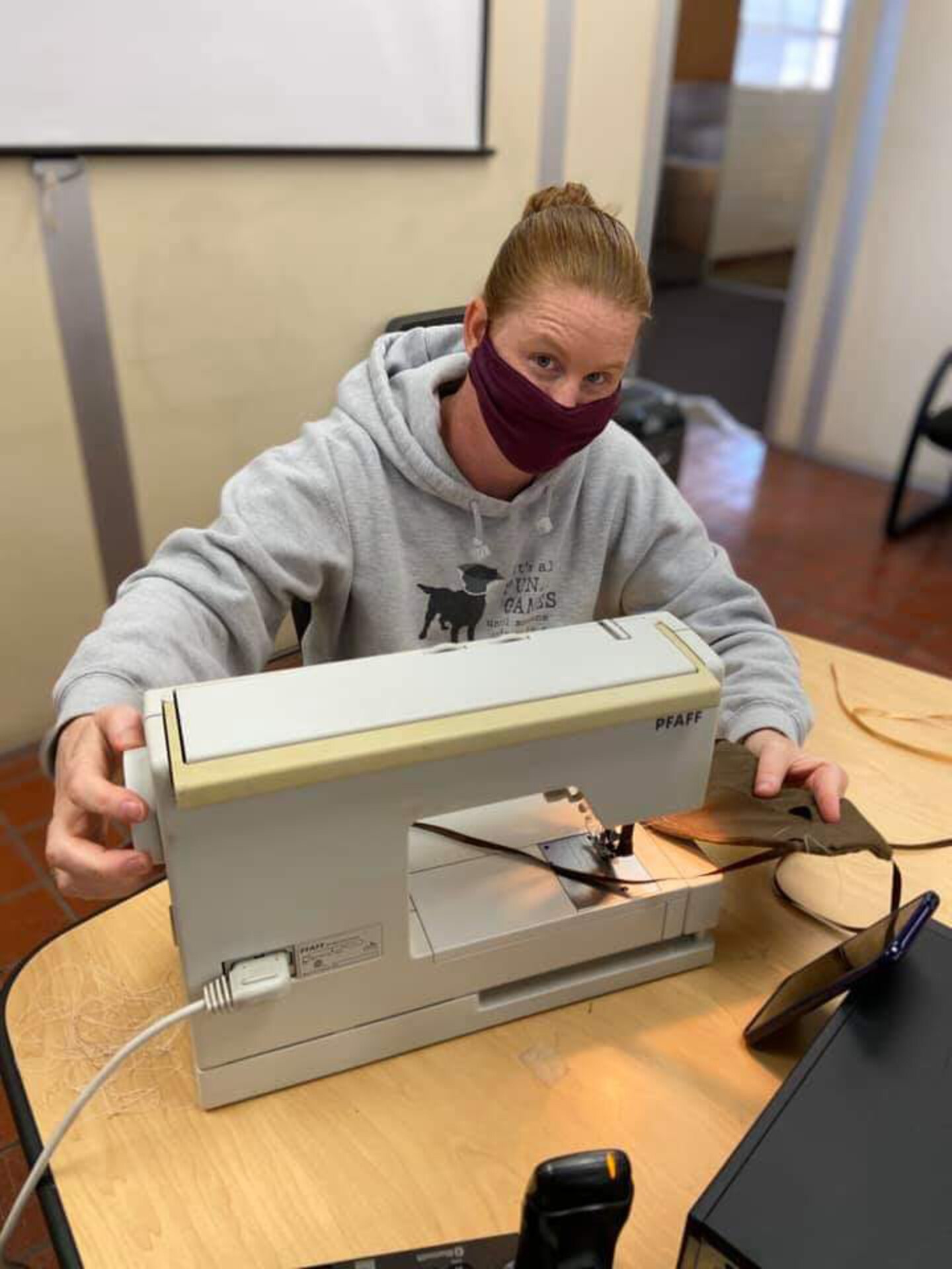 Sergeant 1st Class Kristen Stall, Public Health Activity-San Diego noncommissioned officer in charge of operations, sews together a cloth face covering at the Camp Pendleton Branch Veterinary clinic, April 11, 2020. In response to the COVID-19 pandemic and Secretary of Defense guidance on the use of cloth face coverings, members of PHA-SD worked together to create cloth face coverings to help slow the spread of COVID-19. (Courtesy photo)