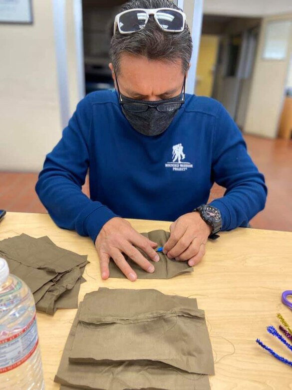 1st Sgt. Florentino Lerma, first sergeant of Public Health Activity-San Diego, sews together a cloth face covering at the Camp Pendleton Branch Veterinary clinic, April 11, 2020. In response to the COVID-19 pandemic and Secretary of Defense guidance on the use of cloth face coverings, members of PHA-SD worked together to create cloth face coverings to help slow the spread of COVID-19. (Courtesy photo)